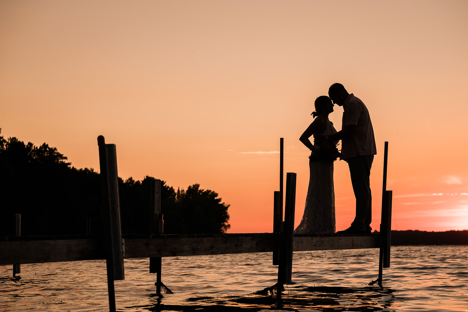Couple silhouette on the dock at orange sunset — Big Trout Lake — Tim Larsen Photography, Brainerd Lakes MN
