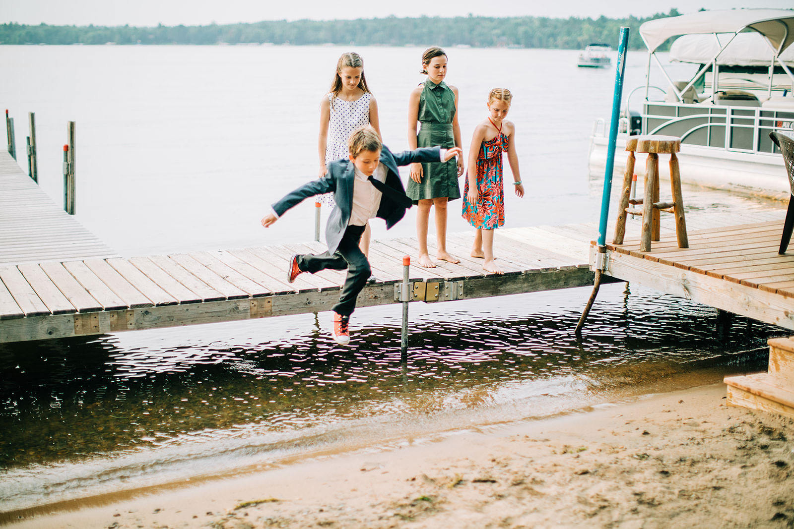 Kids jumping off the dock into Big Trout Lake during the reception — Tim Larsen Photography, Brainerd Lakes MN