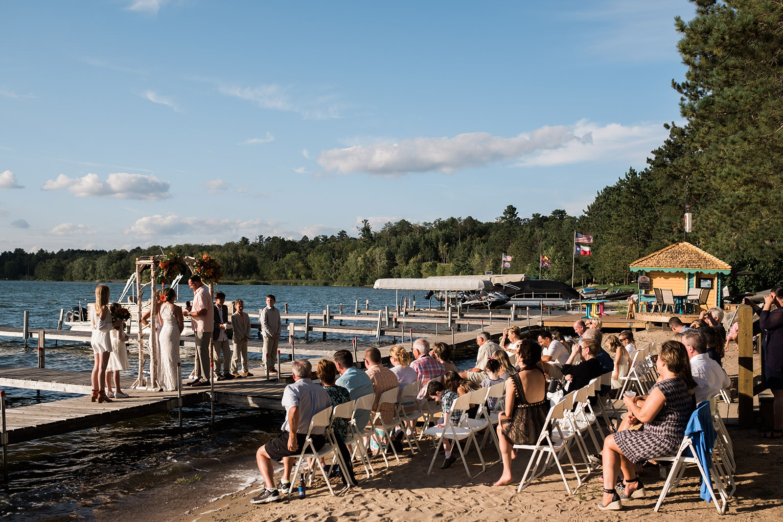 Beach ceremony with guests in chairs on the sand — Big Trout Lake — Tim Larsen Photography, Brainerd Lakes MN