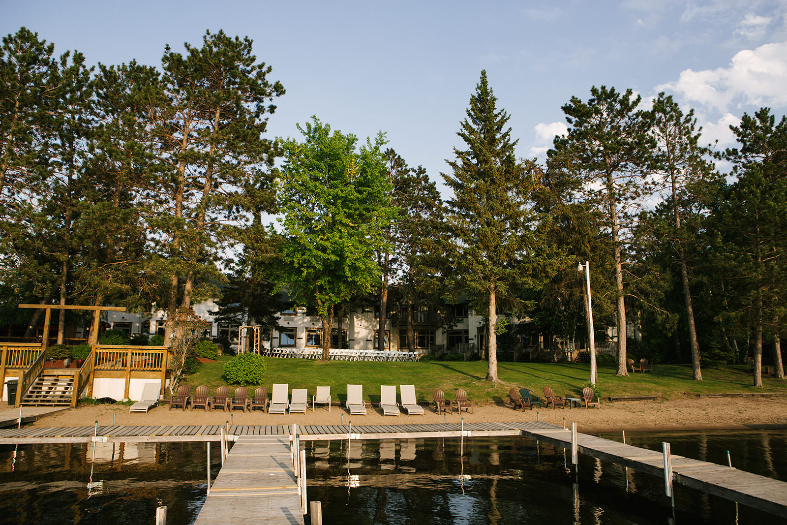 Manhattan Beach Lodge from the water — dock, lawn chairs, and pine trees at golden hour — Tim Larsen Photography, Brainerd Lakes MN