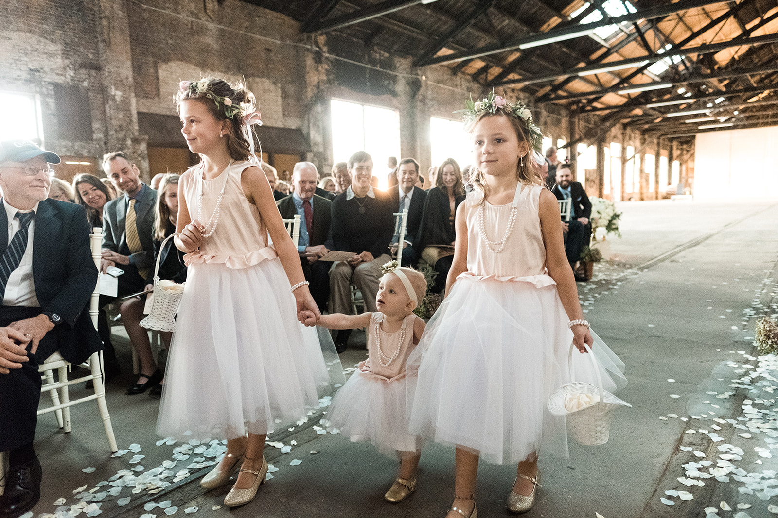 Flower girls walking down the aisle in Three Main — flower crowns and tulle dresses — Tim Larsen Photography, Brainerd Lakes MN