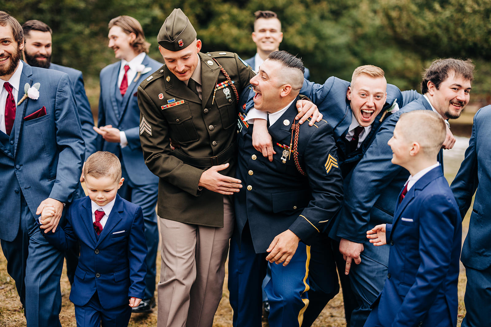 Groomsmen in military uniforms laughing together on the Pine Peaks grounds — Tim Larsen Photography, Brainerd Lakes MN