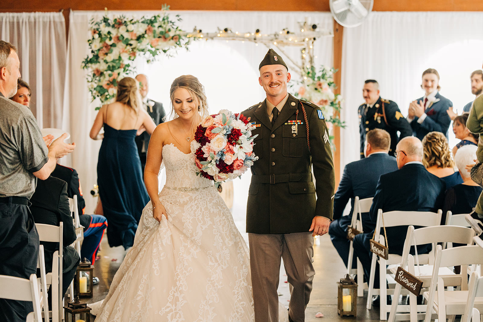 Couple recessional in the Pine Peaks event hall — military uniform and lace gown — Tim Larsen Photography, Brainerd Lakes MN