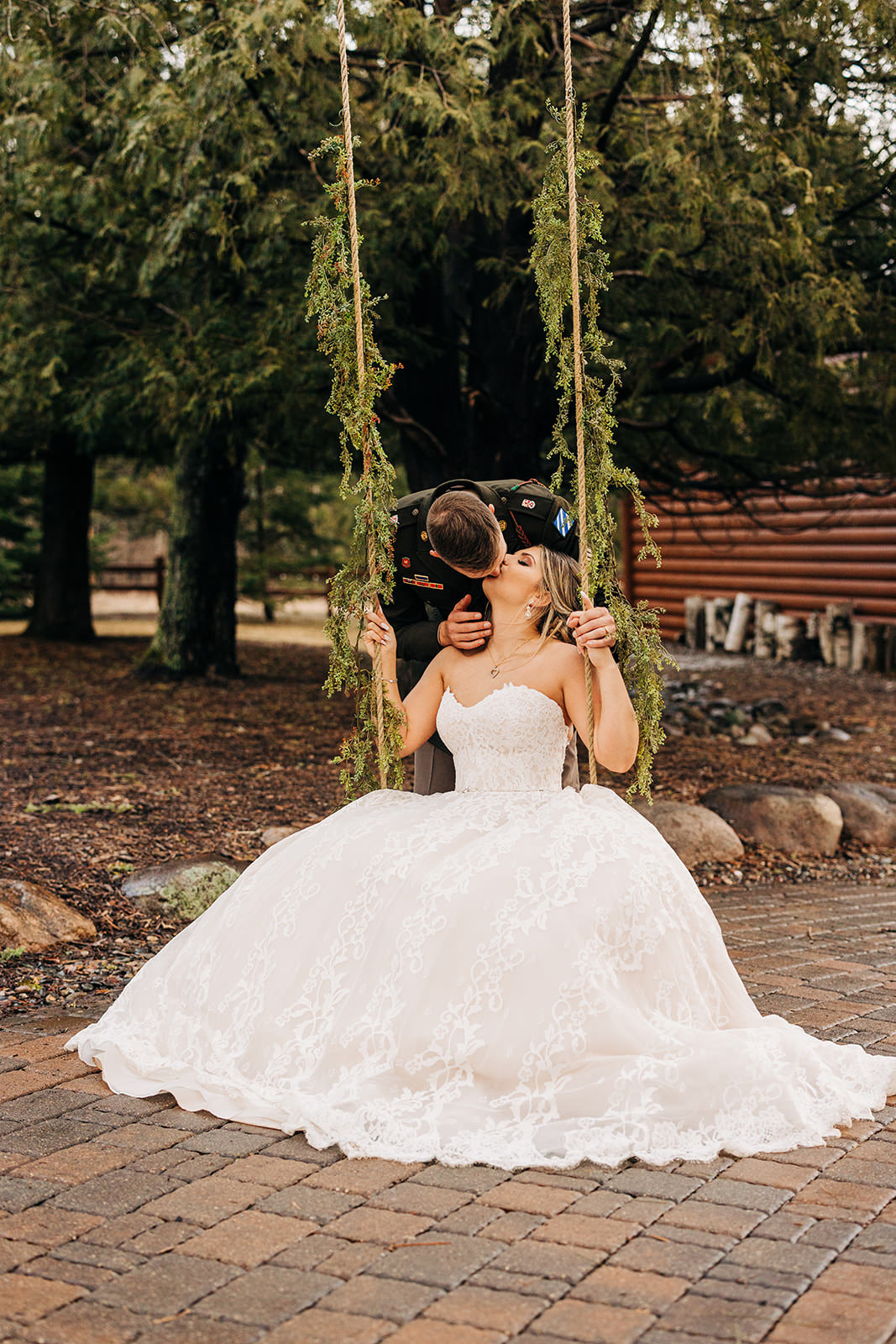 Couple kissing on a tree swing in the Pine Peaks gardens — Tim Larsen Photography, Brainerd Lakes MN