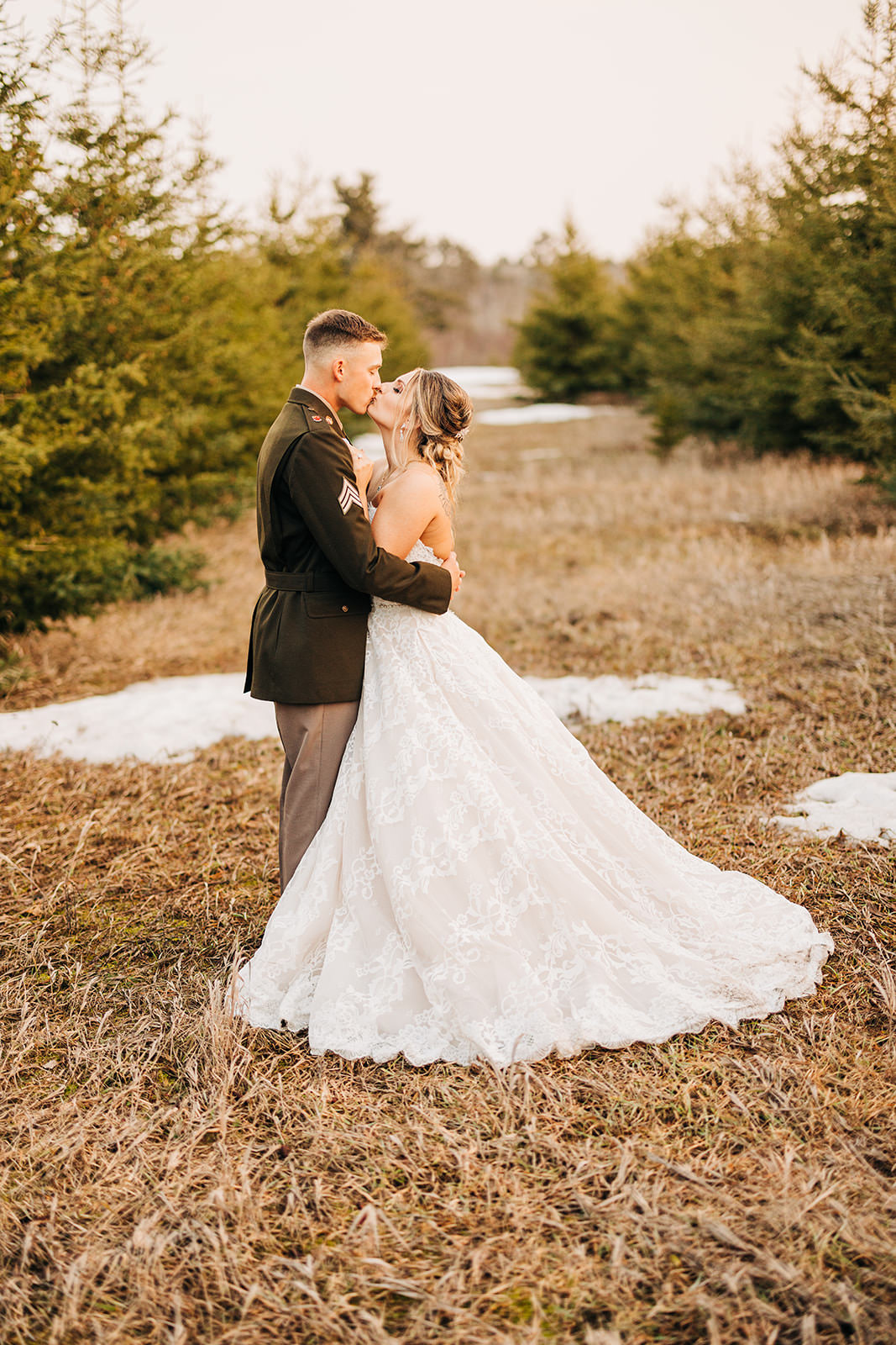 Couple embracing in the field with patches of snow — military dress uniform at golden hour — Tim Larsen Photography, Brainerd Lakes MN
