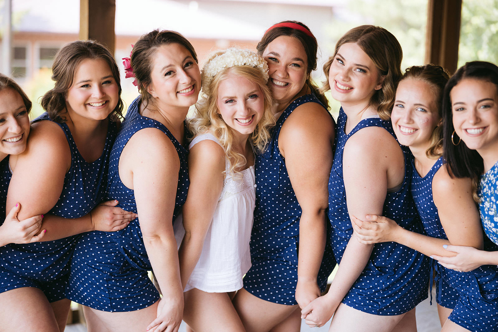Bride and bridesmaids in navy polka dot pajamas — getting ready together — Tim Larsen Photography, Brainerd Lakes MN