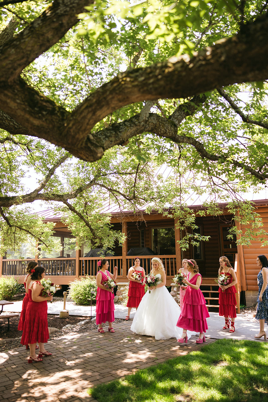 Bride with bridesmaids in hot pink dresses under the big oak tree at Pine Peaks — Tim Larsen Photography, Brainerd Lakes MN