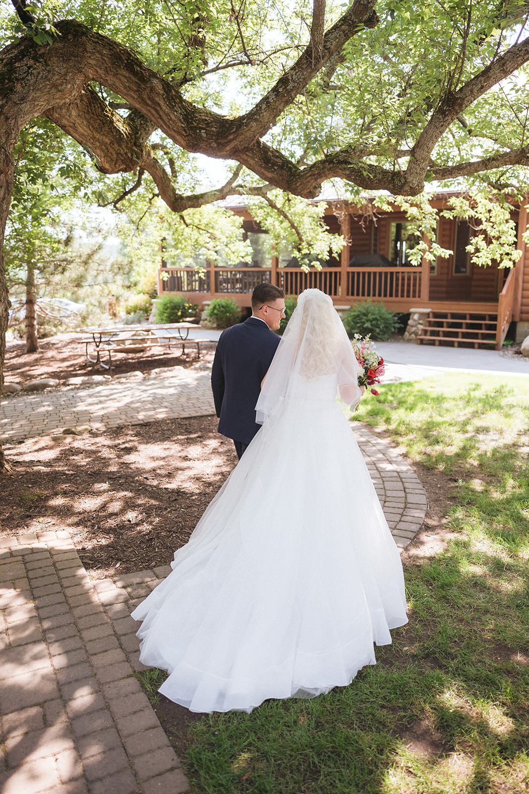 Couple walking away under the big oak tree toward the lodge at Pine Peaks — Tim Larsen Photography, Brainerd Lakes MN