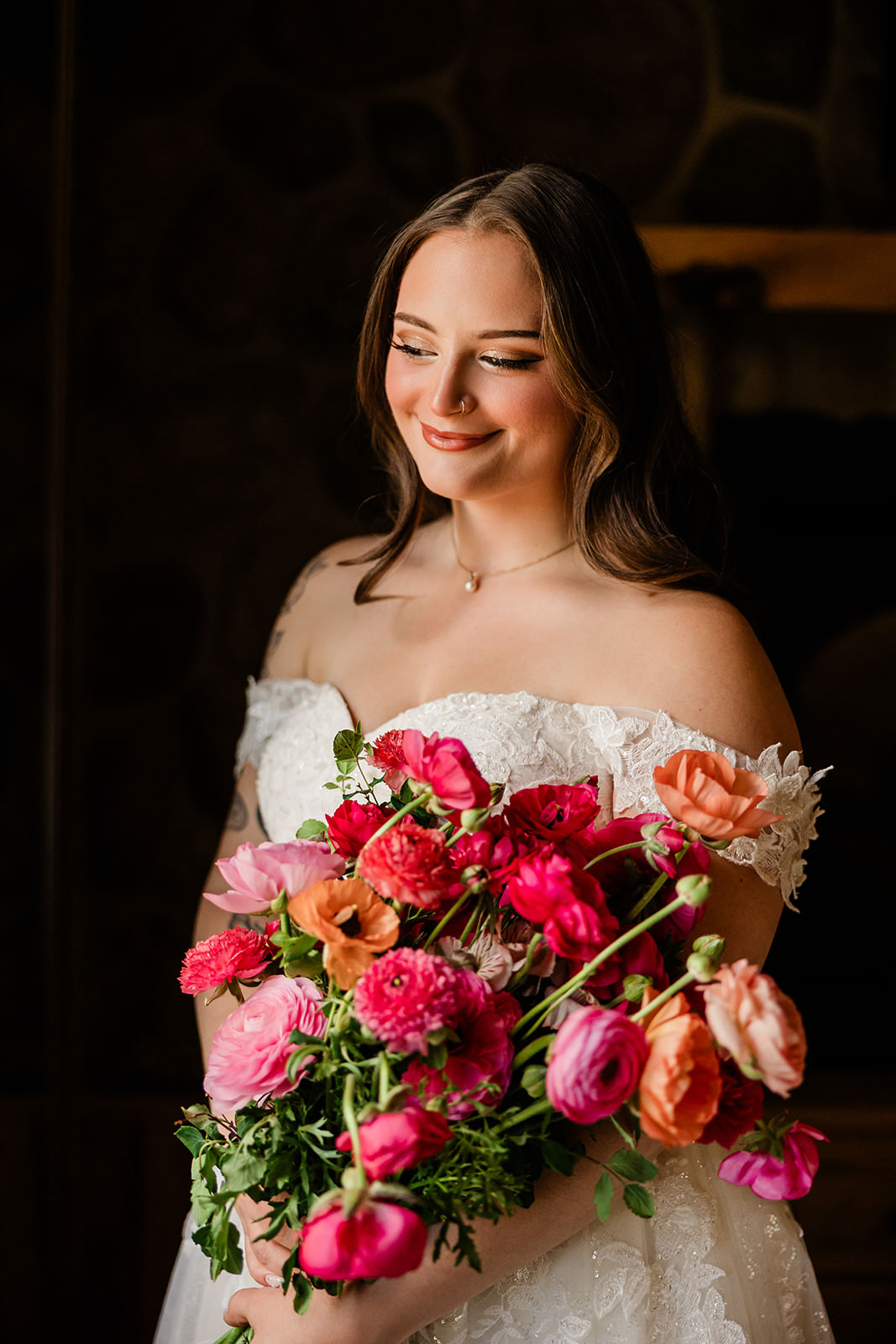 Bridal portrait with pink and coral bouquet — warm fireplace light — Tim Larsen Photography, Brainerd Lakes MN