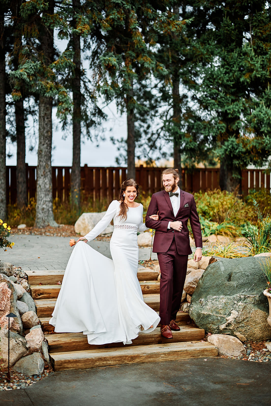 Couple walking down stone steps through the landscaped garden at Pine Peaks — Tim Larsen Photography, Brainerd Lakes MN