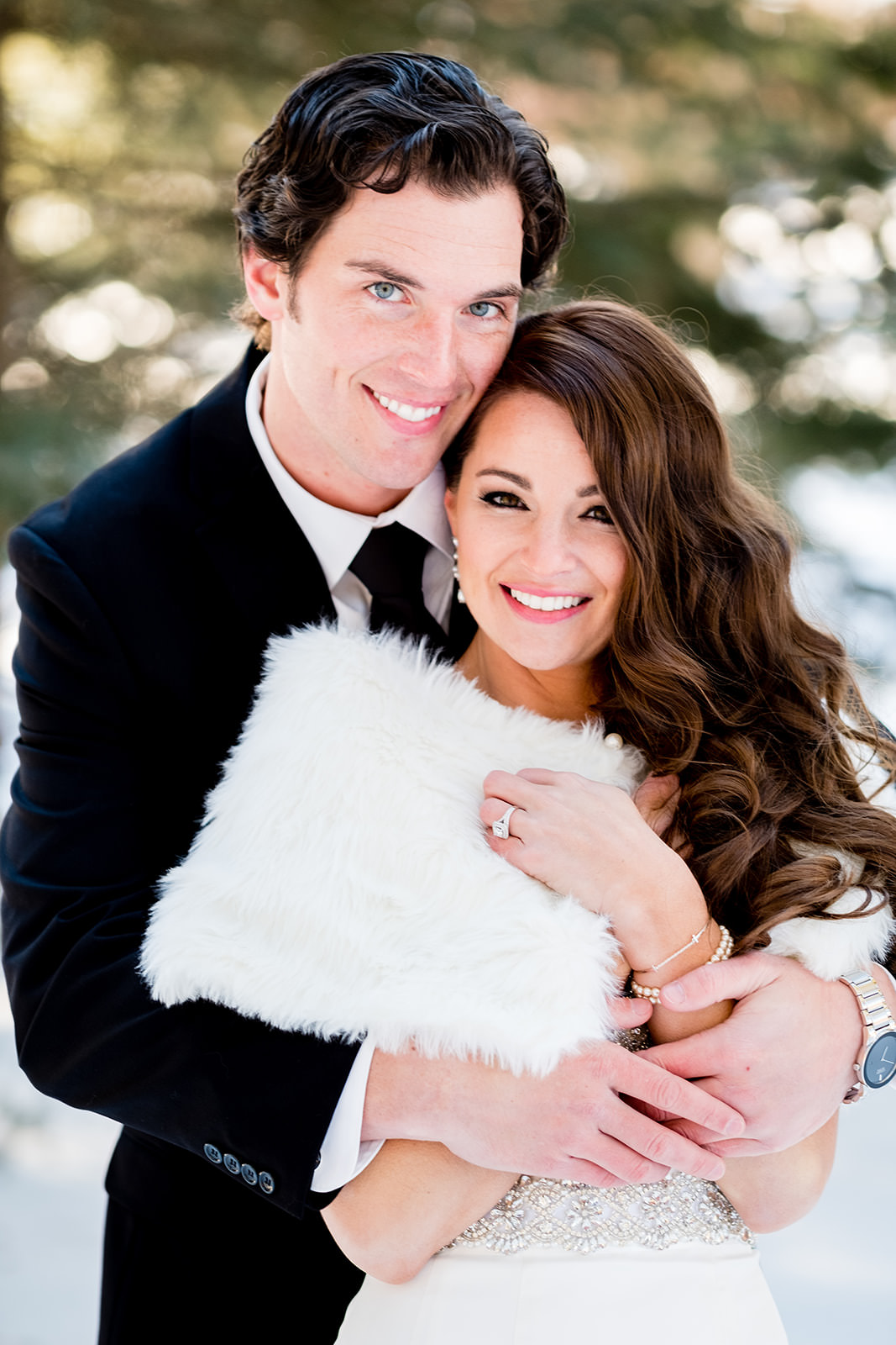 Couple portrait in the snow — white fur wrap and bright smiles — Tim Larsen Photography, Brainerd Lakes MN
