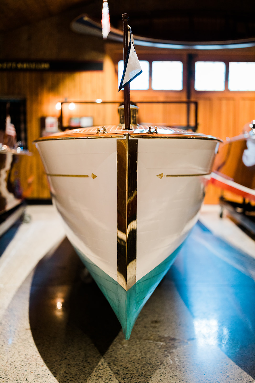 Vintage wooden boat displayed inside a lakeside boathouse — Tim Larsen Photography, Brainerd Lakes MN