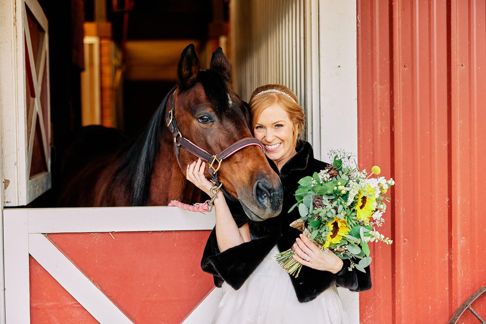 Bride holding sunflower bouquet posing with horse at a red barn — Tim Larsen Photography, Brainerd Lakes MN