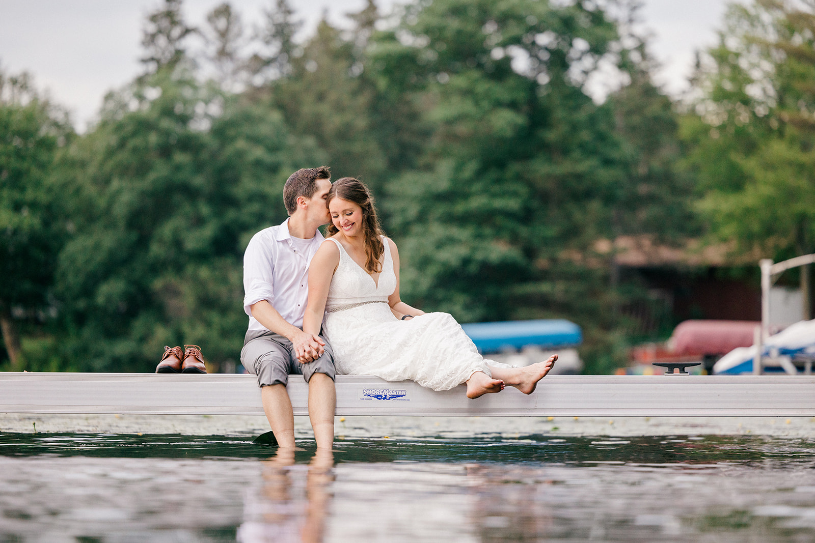 Couple sitting barefoot on the dock with feet dangling over the water — Tim Larsen Photography, Brainerd Lakes MN