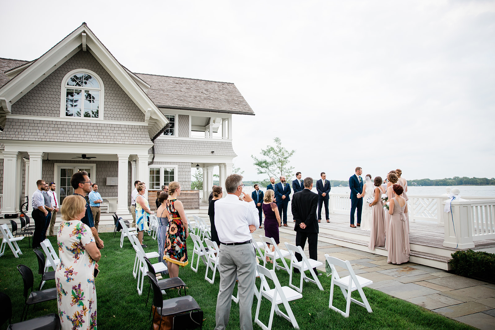 Lakeside ceremony on the lawn beside a shingled lake home — Tim Larsen Photography, Brainerd Lakes MN
