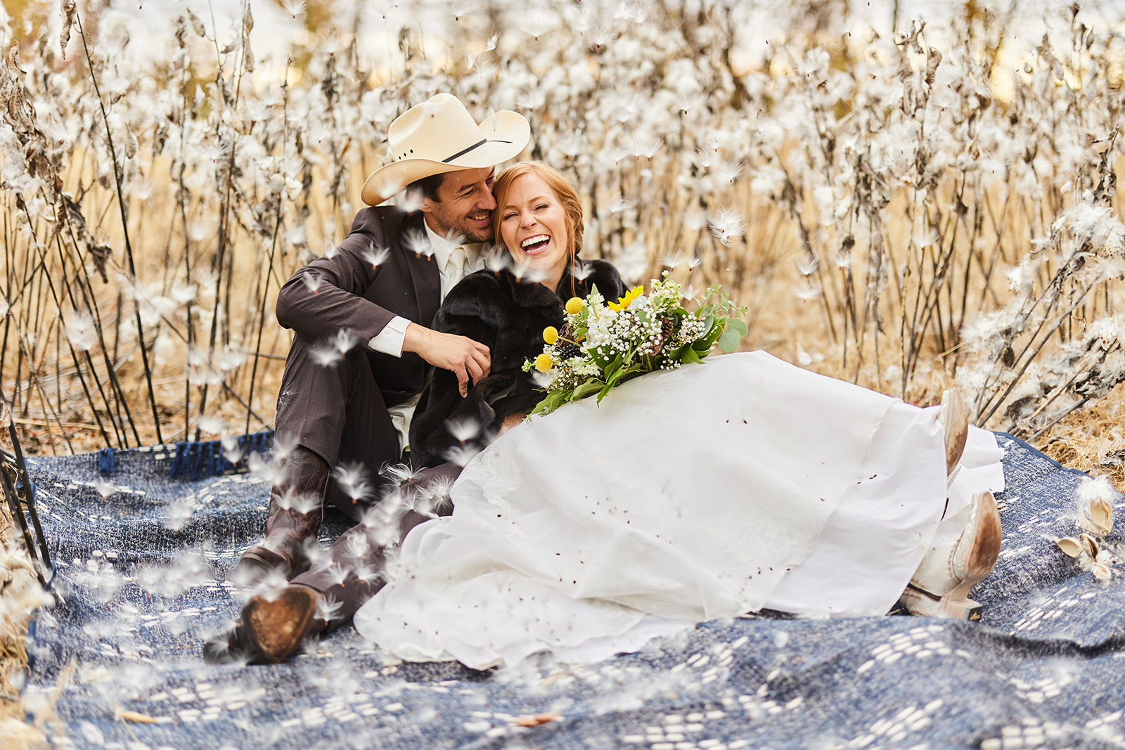 Couple laughing on a blanket in a sun-drenched field of dried wildflowers — Tim Larsen Photography, Brainerd Lakes MN