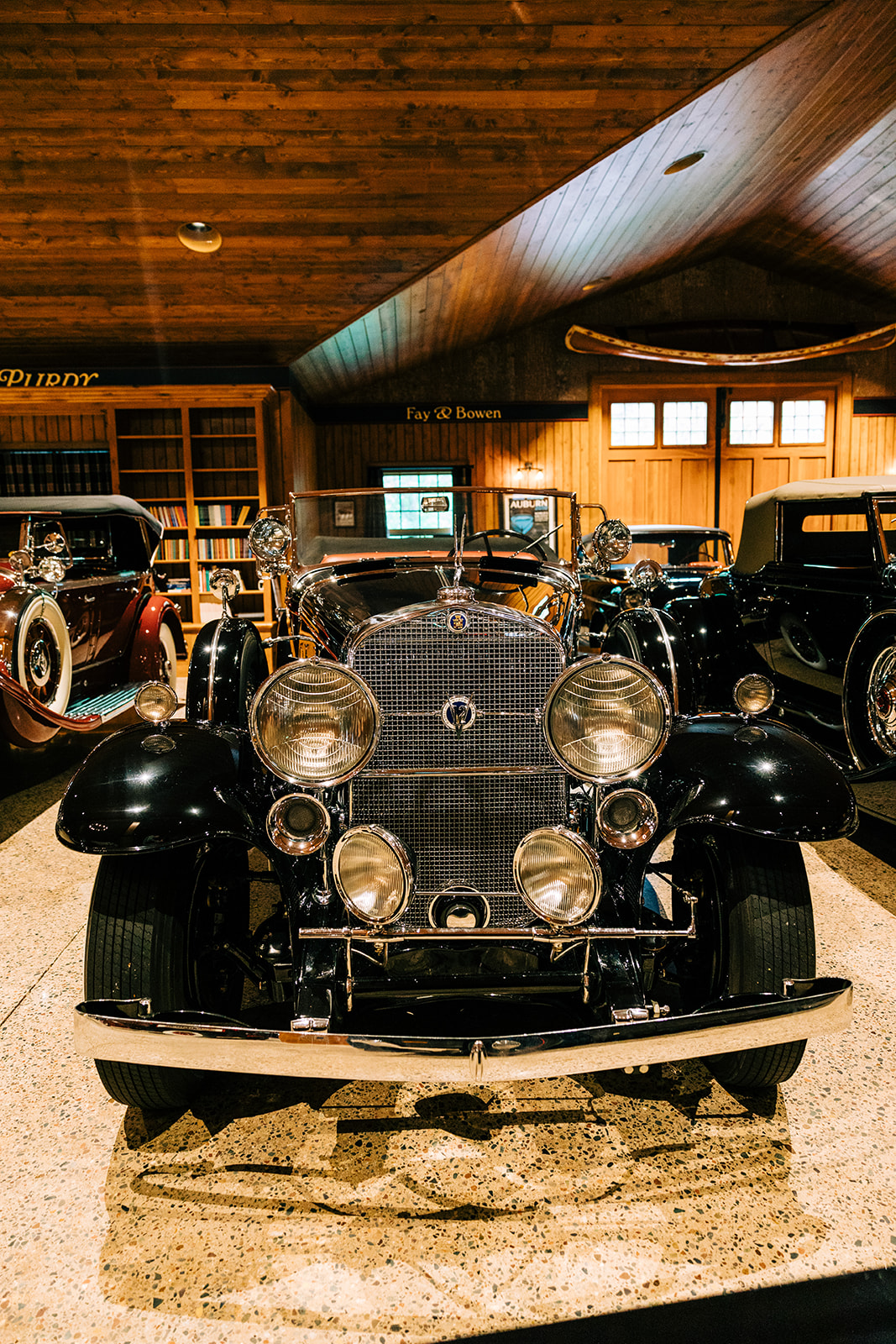 Vintage black automobile on display inside a wooden car collection building — Tim Larsen Photography, Brainerd Lakes MN
