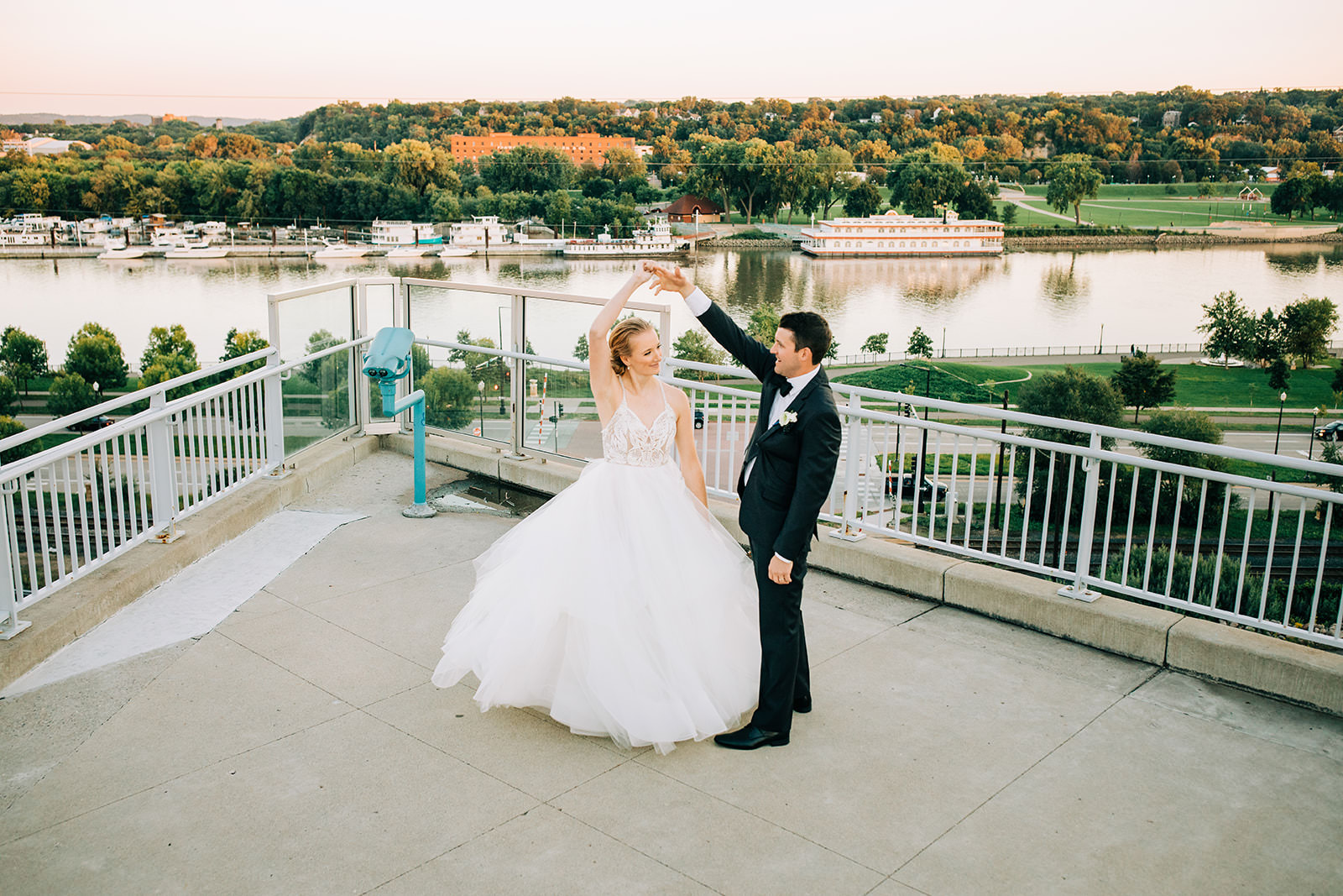 Bride spinning on a rooftop overlooking the St. Paul river at sunset — Tim Larsen Photography, Brainerd Lakes MN