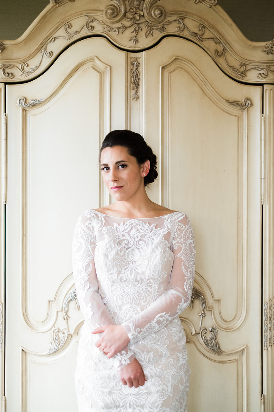 Bridal portrait in a long-sleeve lace gown against ornate white doors — Tim Larsen Photography, Brainerd Lakes MN