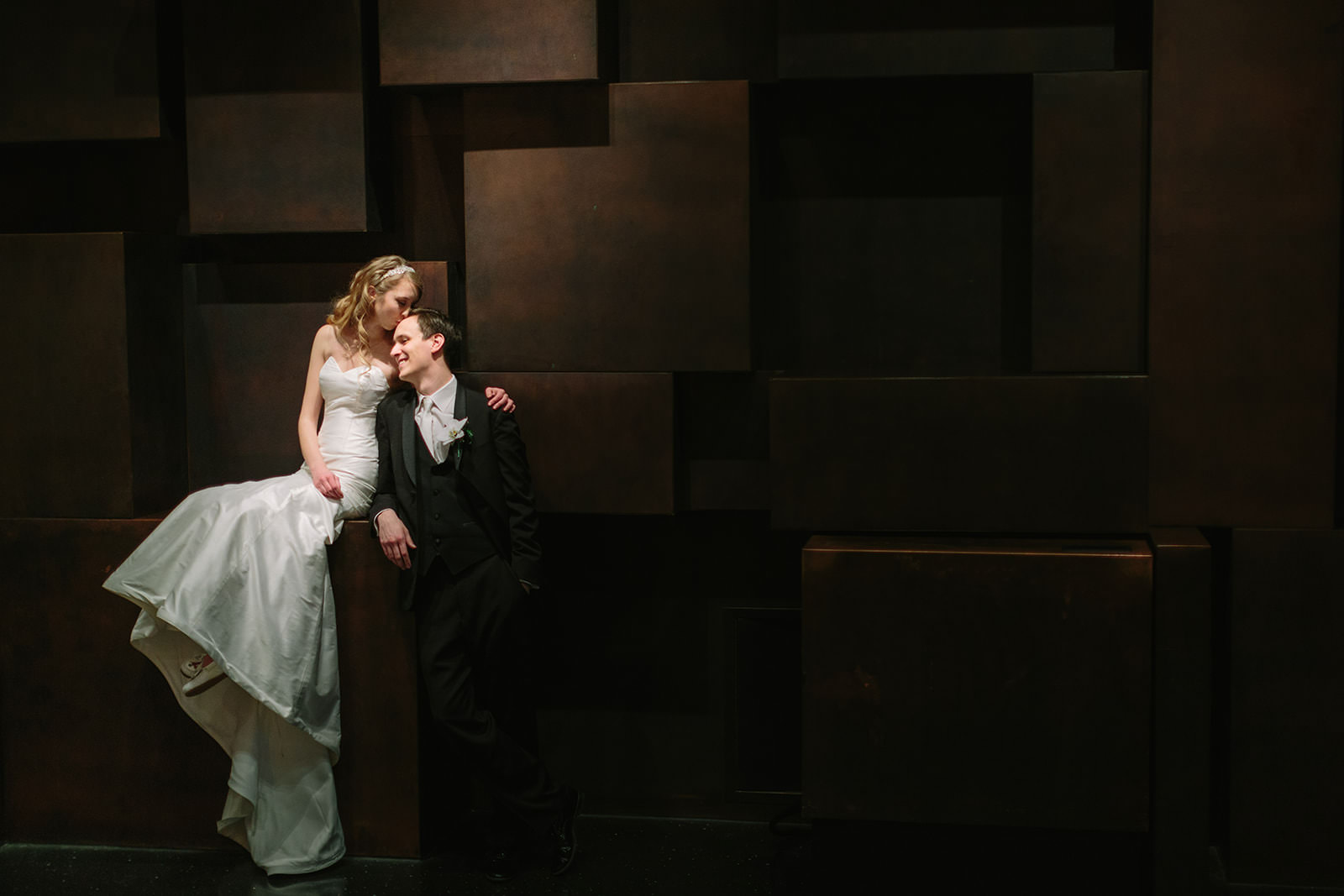 Couple on a modern sculptural stage wall — editorial portrait at a Minneapolis venue — Tim Larsen Photography, Brainerd Lakes MN