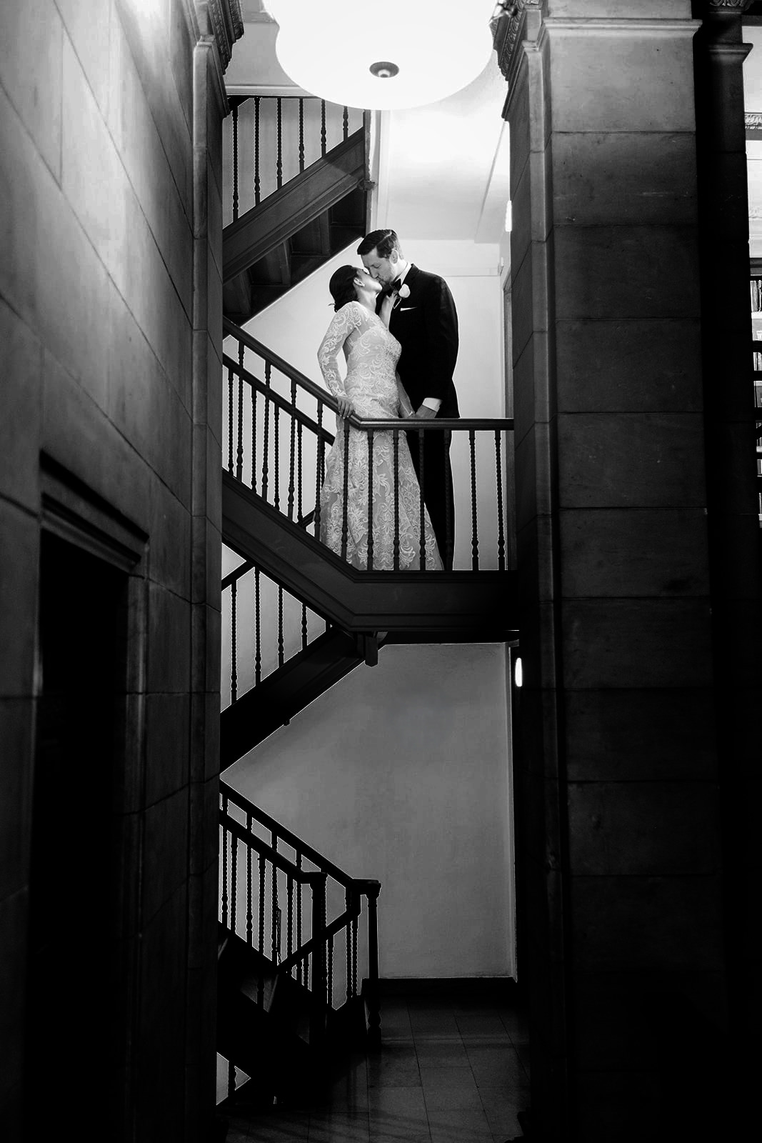 Couple kissing on a historic stone staircase in black and white — Twin Cities venue — Tim Larsen Photography, Brainerd Lakes MN