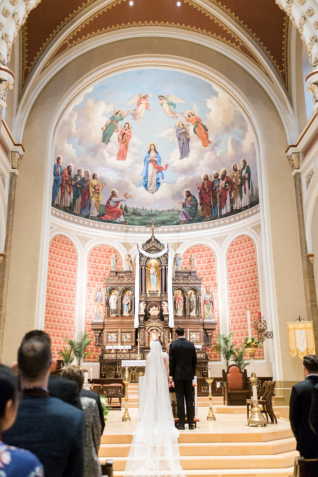 Ceremony at the altar with painted mural and ornate columns — Minneapolis cathedral — Tim Larsen Photography, Brainerd Lakes MN