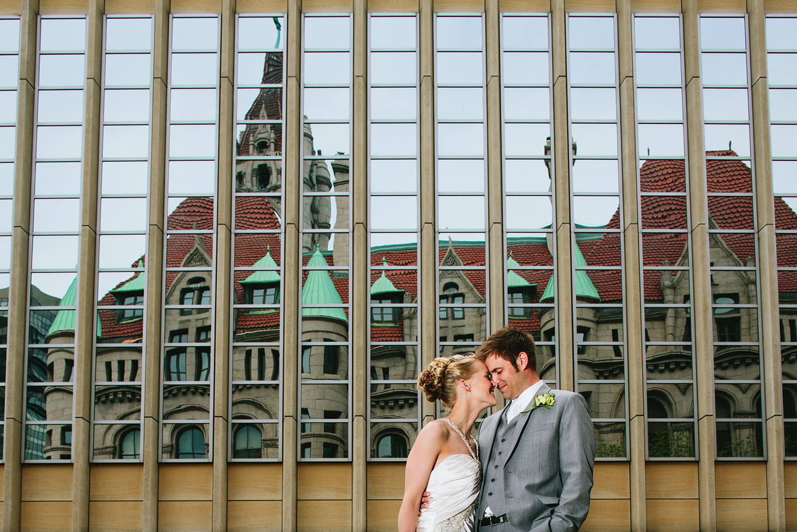 Couple portrait with Minneapolis Landmark Center reflected in glass building facade — Tim Larsen Photography, Brainerd Lakes MN