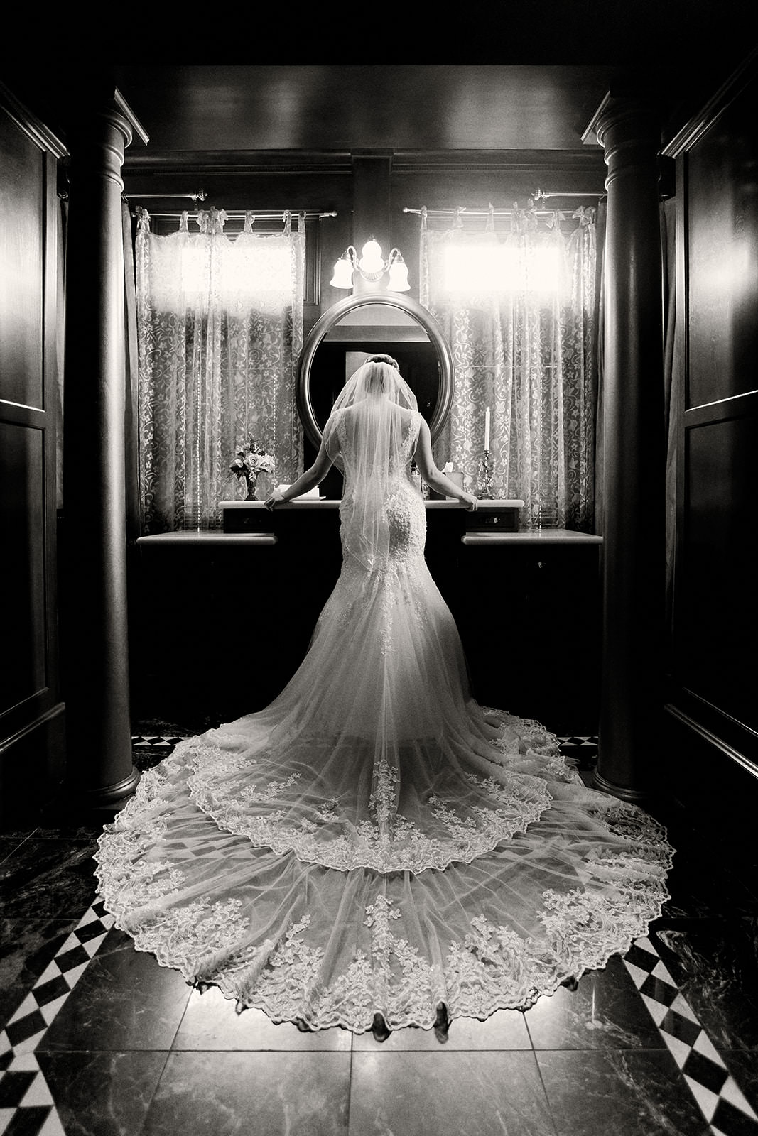 Bride with cathedral lace veil in a dark getting-ready room in black and white — Tim Larsen Photography, Brainerd Lakes MN