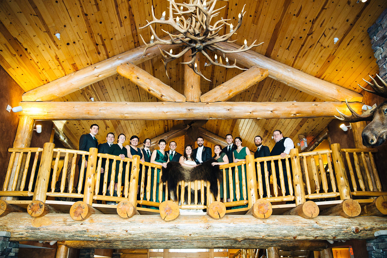 Groomsmen on the log balcony with antler chandelier at Whitefish Lodge — Tim Larsen Photography, Brainerd Lakes MN