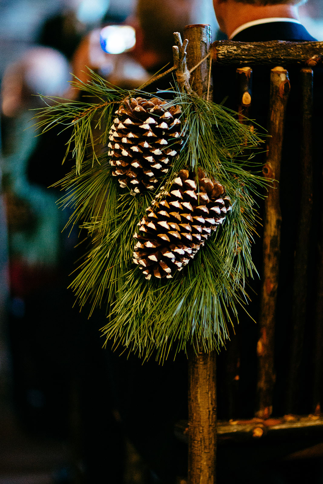 Pine cone and greenery detail on rustic chair at Whitefish Lodge — Tim Larsen Photography, Brainerd Lakes MN