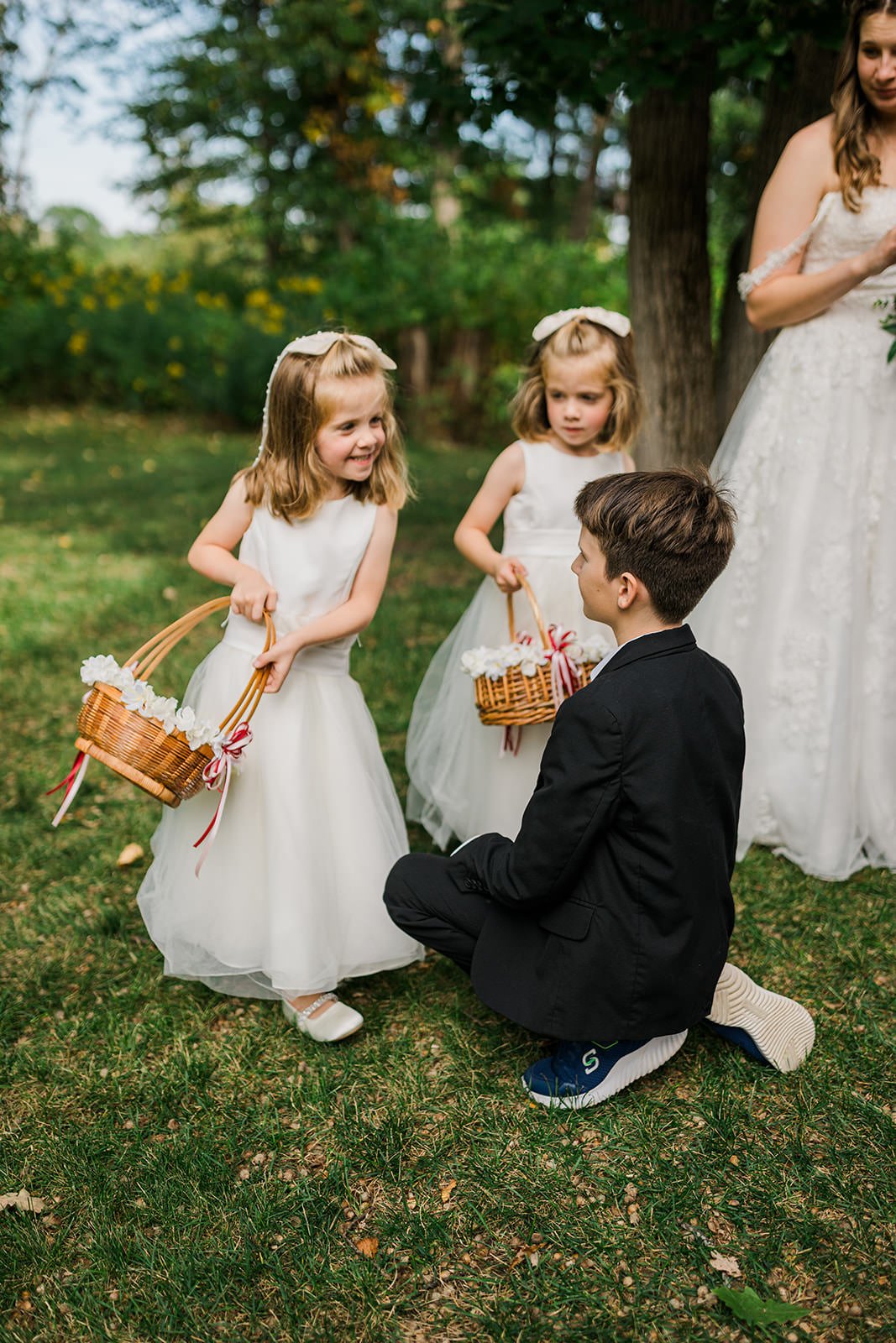 Flower girls with baskets and ring bearer on the grounds at Whitefish Lodge — Tim Larsen Photography, Brainerd Lakes MN
