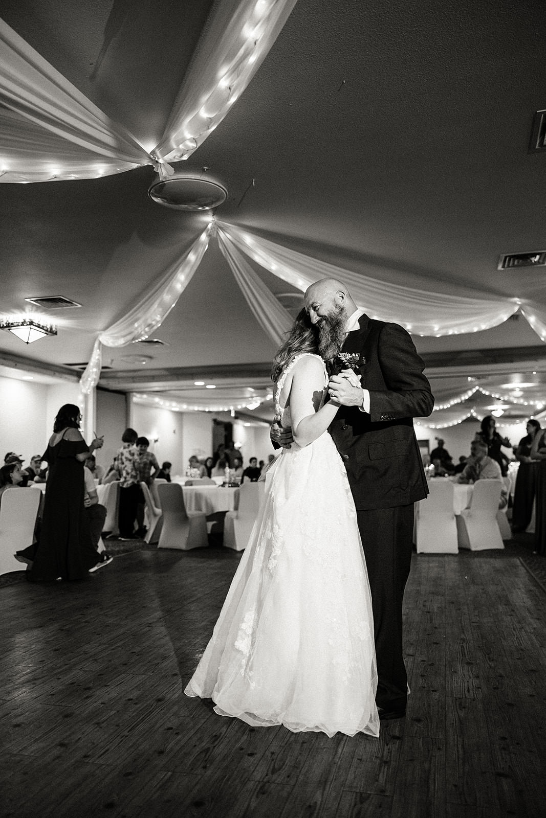 First dance in black and white — draping and string lights at Whitefish Lodge reception — Tim Larsen Photography, Brainerd Lakes MN
