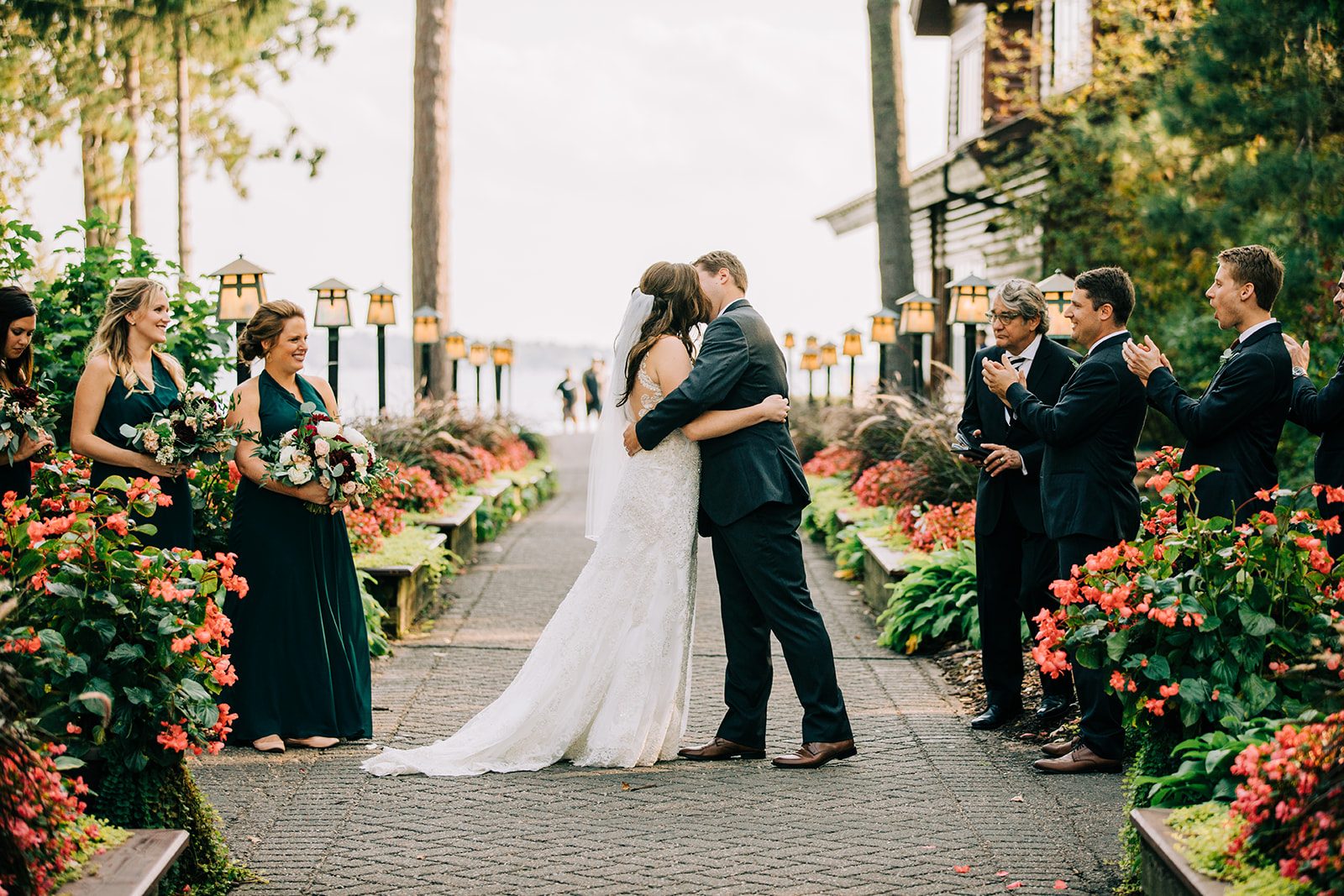 Recessional at Grand View Lodge — symmetrical aisle with bridal party and lit lanterns receding to the lake — Tim Larsen Photography, Brainerd Lakes MN