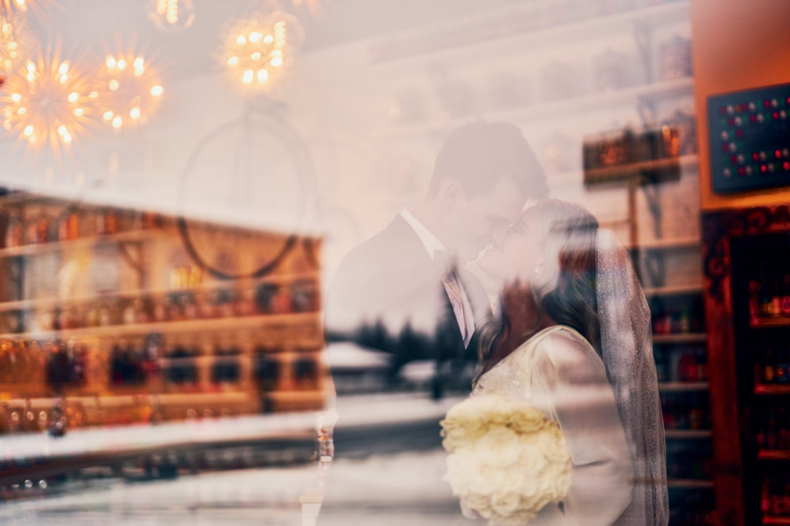Layered window reflection of bar interior over couple in tender forehead-to-forehead pose — Tim Larsen Photography, Brainerd Lakes MN
