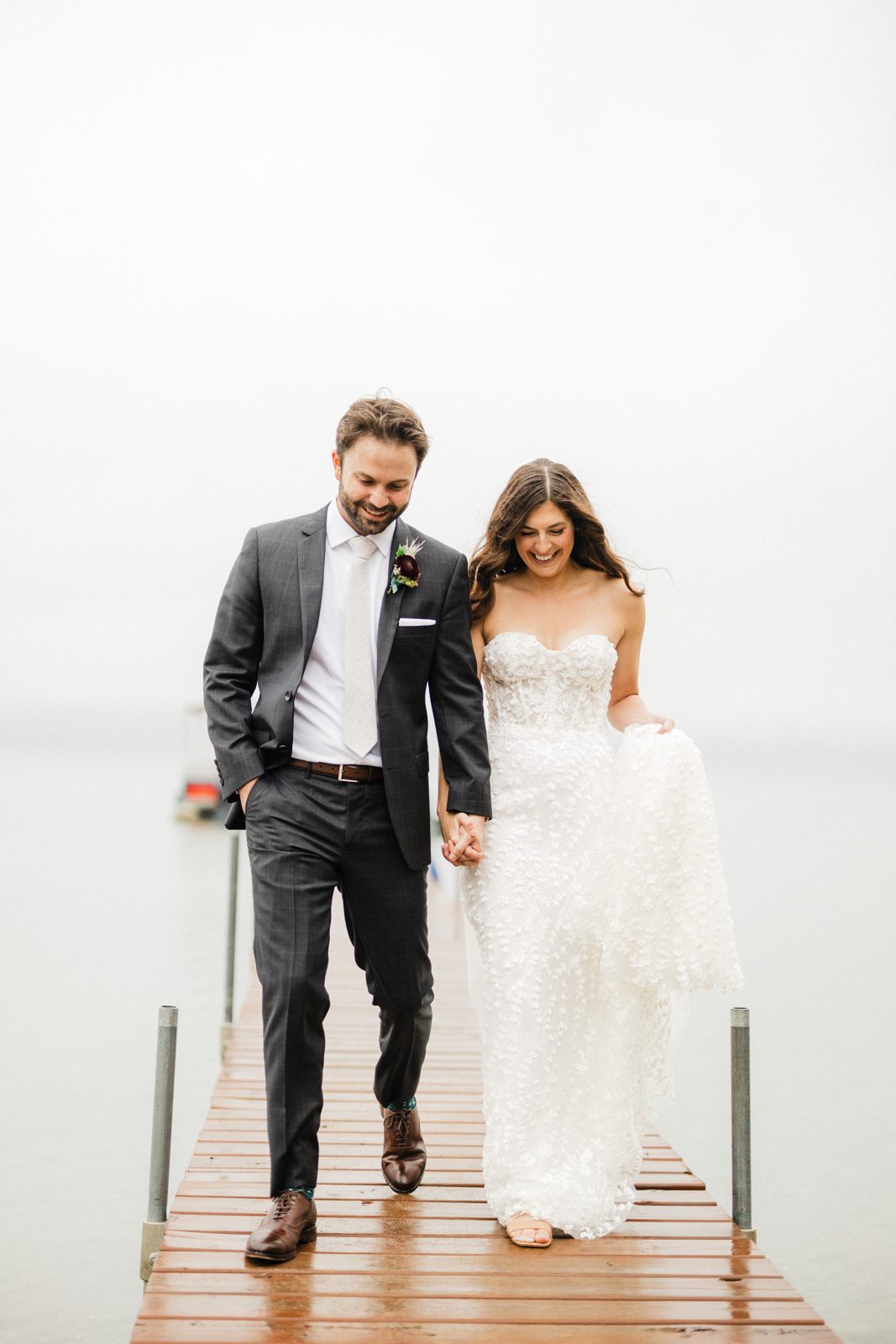 Centered couple walking dock, soft foggy lake recedes into white negative space. — Tim Larsen Photography, Brainerd Lakes MN