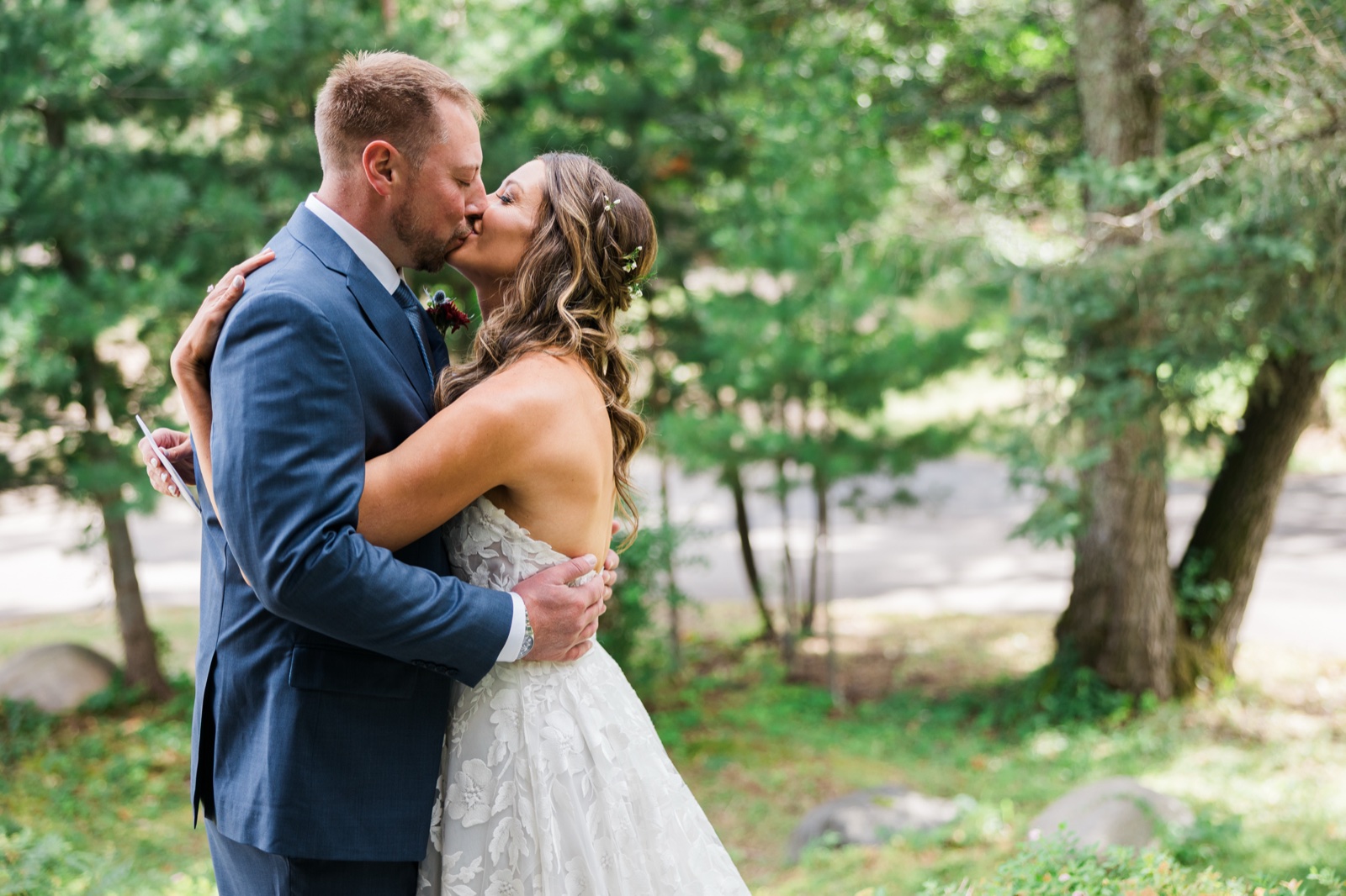 Bride and groom kiss on a wooded path after private vows near Manhattan Beach Lodge — Tim Larsen Photography, Brainerd Lakes MN