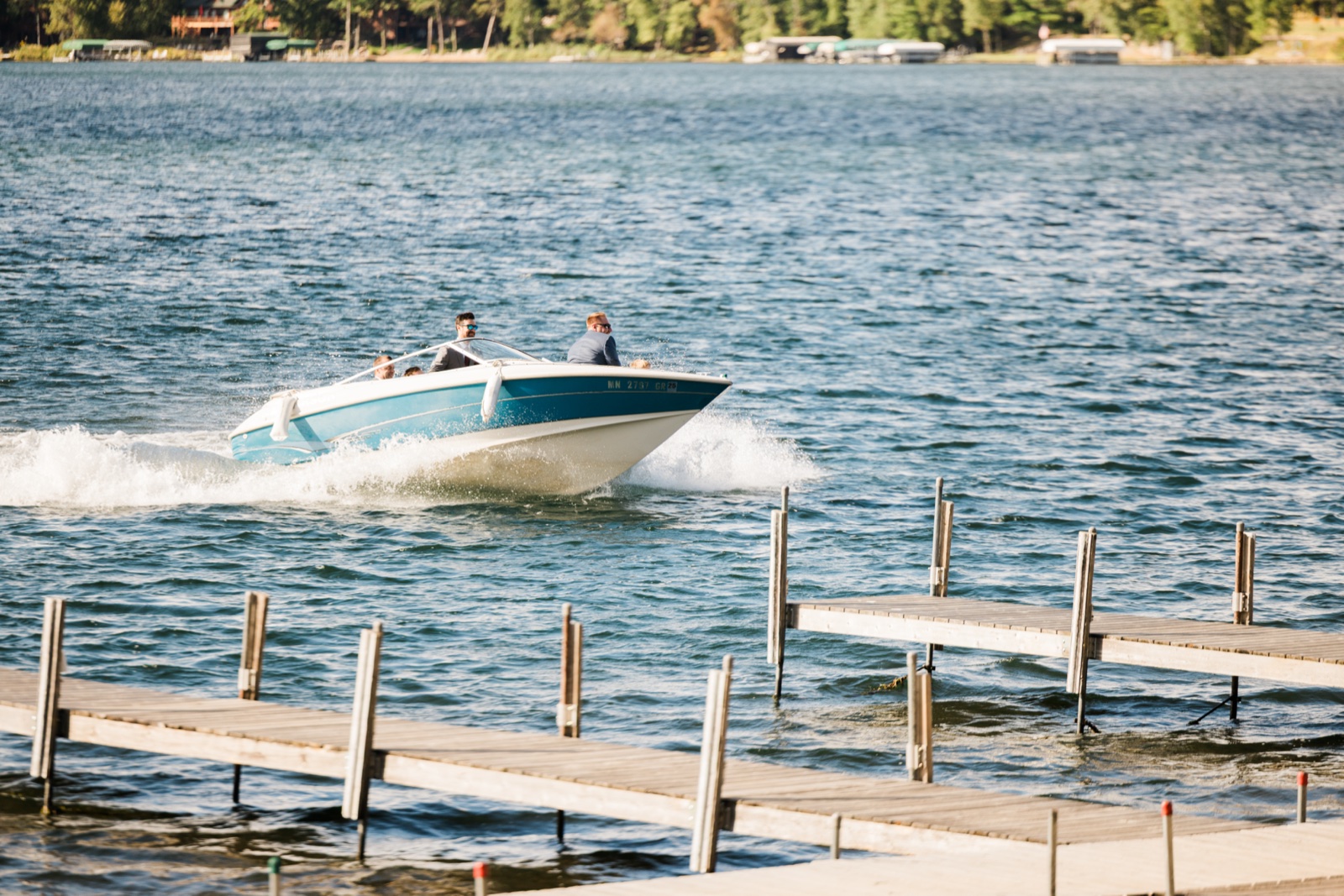 Vintage speedboat cuts across Big Trout Lake past the docks at Manhattan Beach Lodge — Tim Larsen Photography, Brainerd Lakes MN