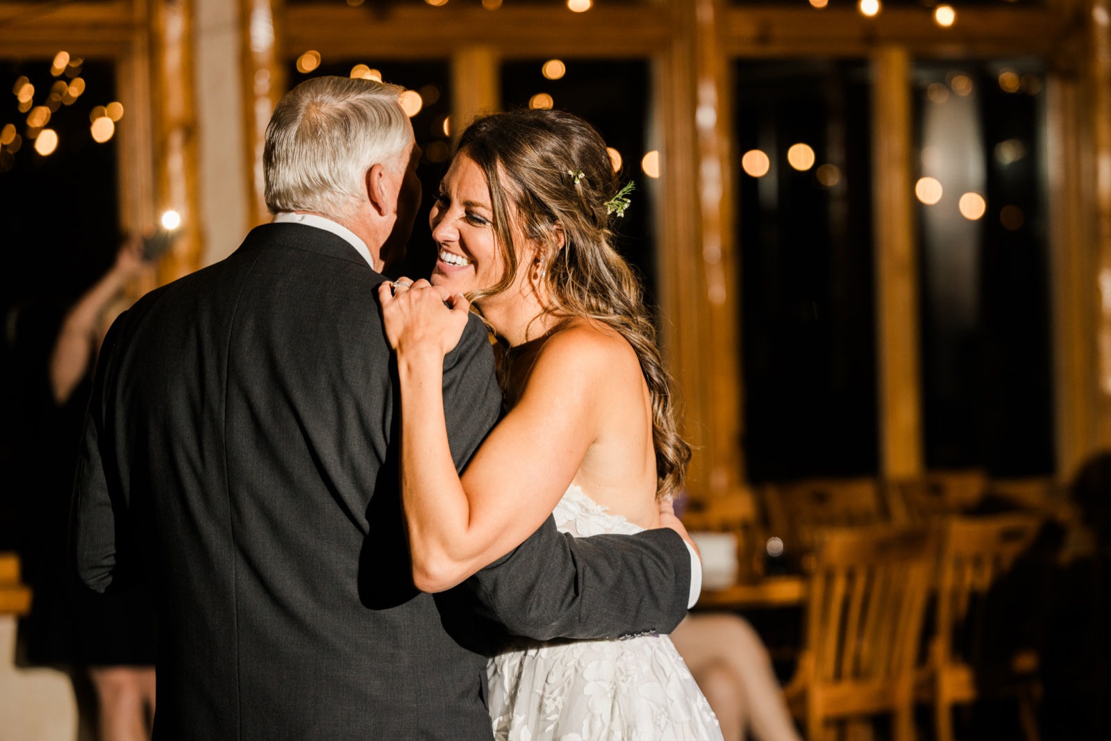 Father-daughter dance under string lights at the Manhattan Beach Lodge reception — Tim Larsen Photography, Brainerd Lakes MN