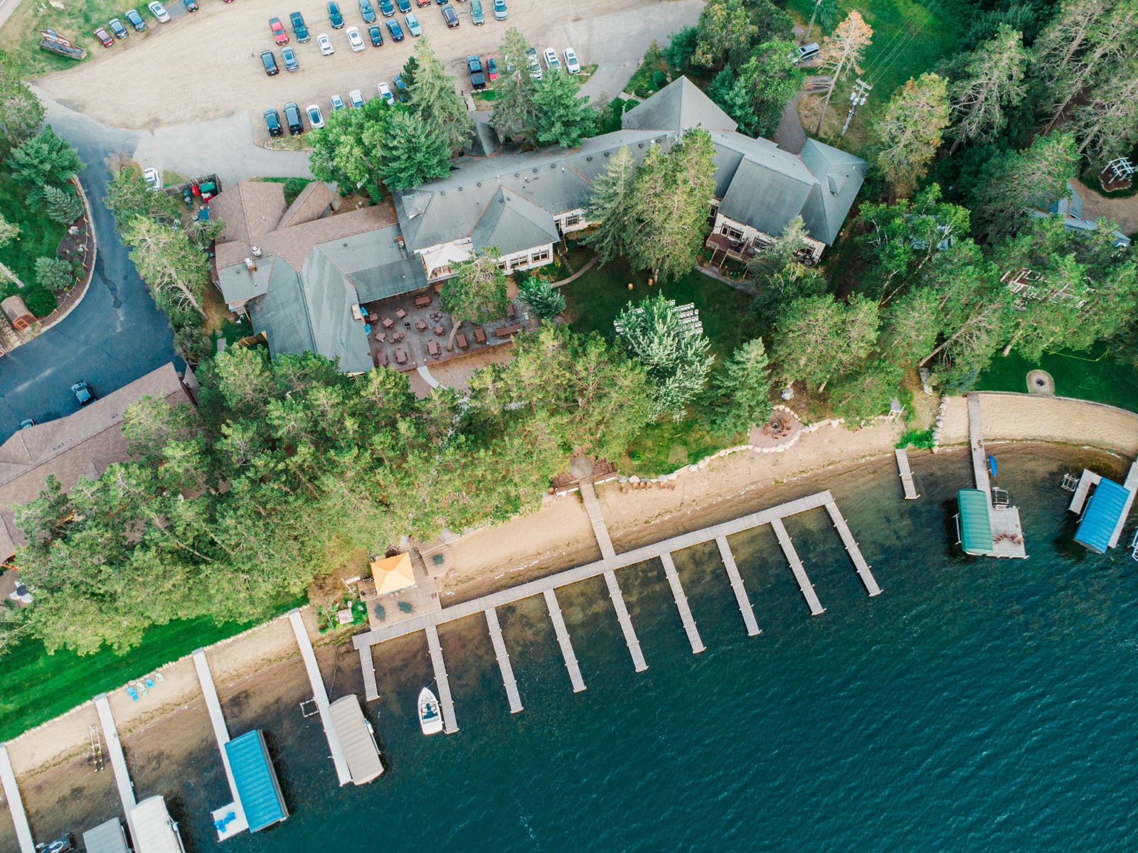 Aerial view of Manhattan Beach Lodge, ceremony lawn, and dock on Big Trout Lake — Tim Larsen Photography, Brainerd Lakes MN