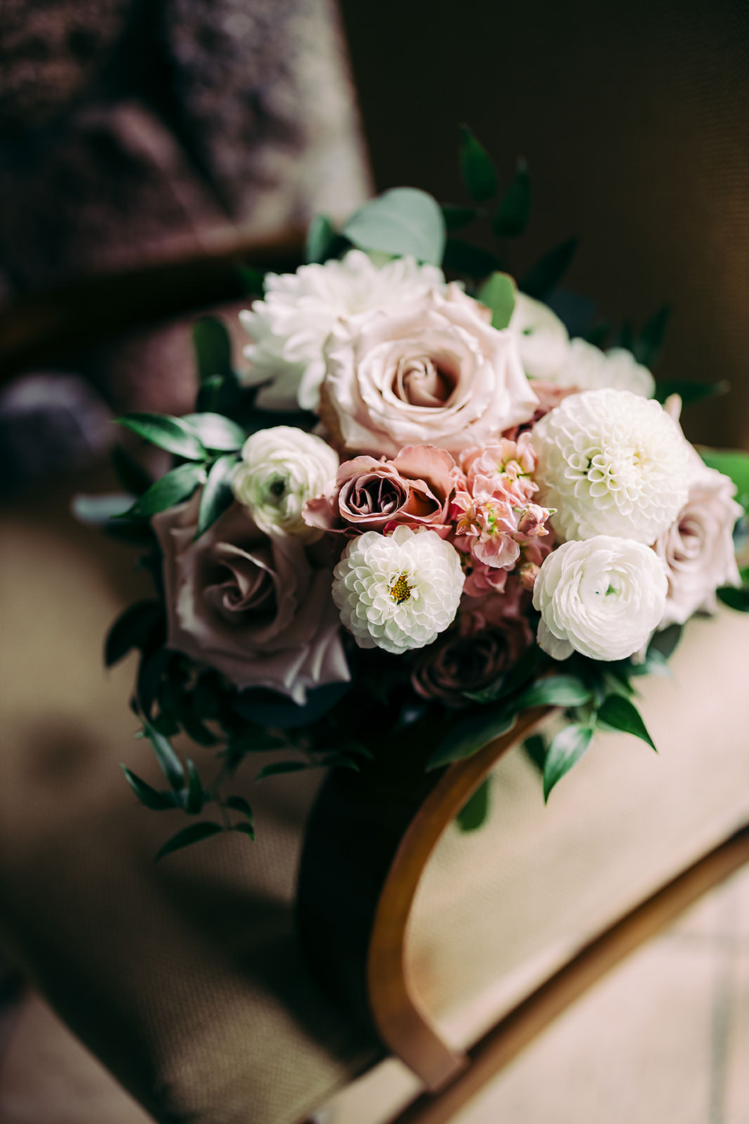 Bridal bouquet — garden roses, white peonies, ranunculus, dusty purple blooms, and eucalyptus — Tim Larsen Photography, Brainerd Lakes MN