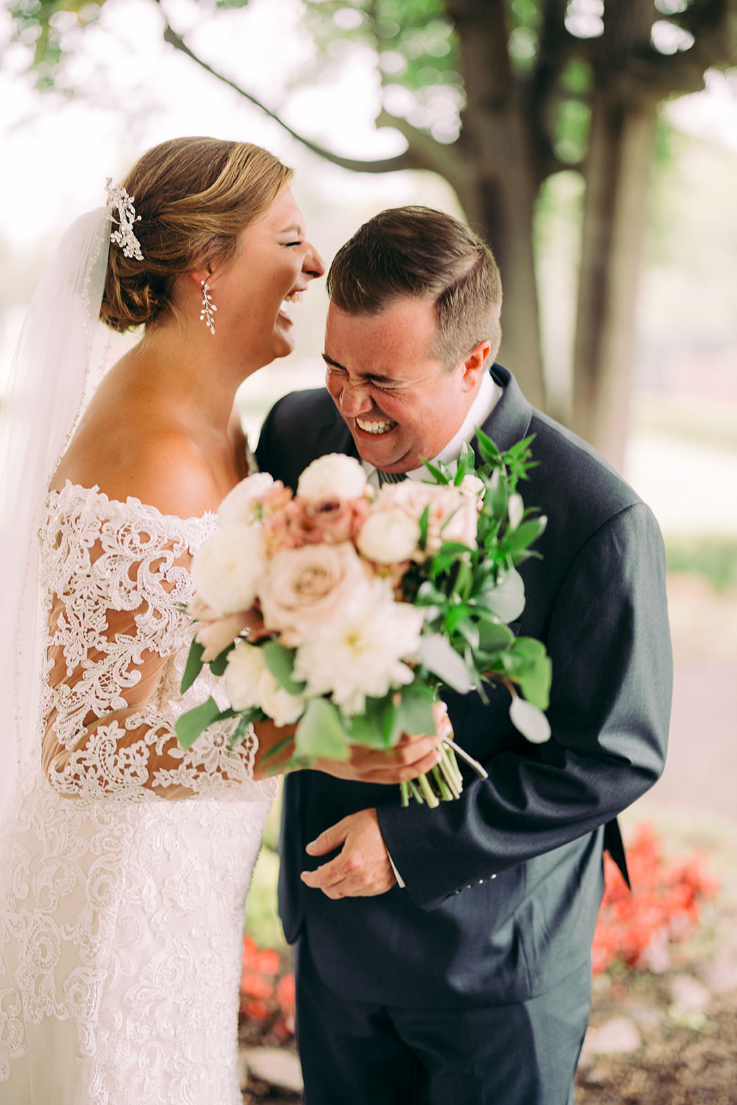 Groom laughing into the bridal bouquet after the first look — Tim Larsen Photography, Brainerd Lakes MN