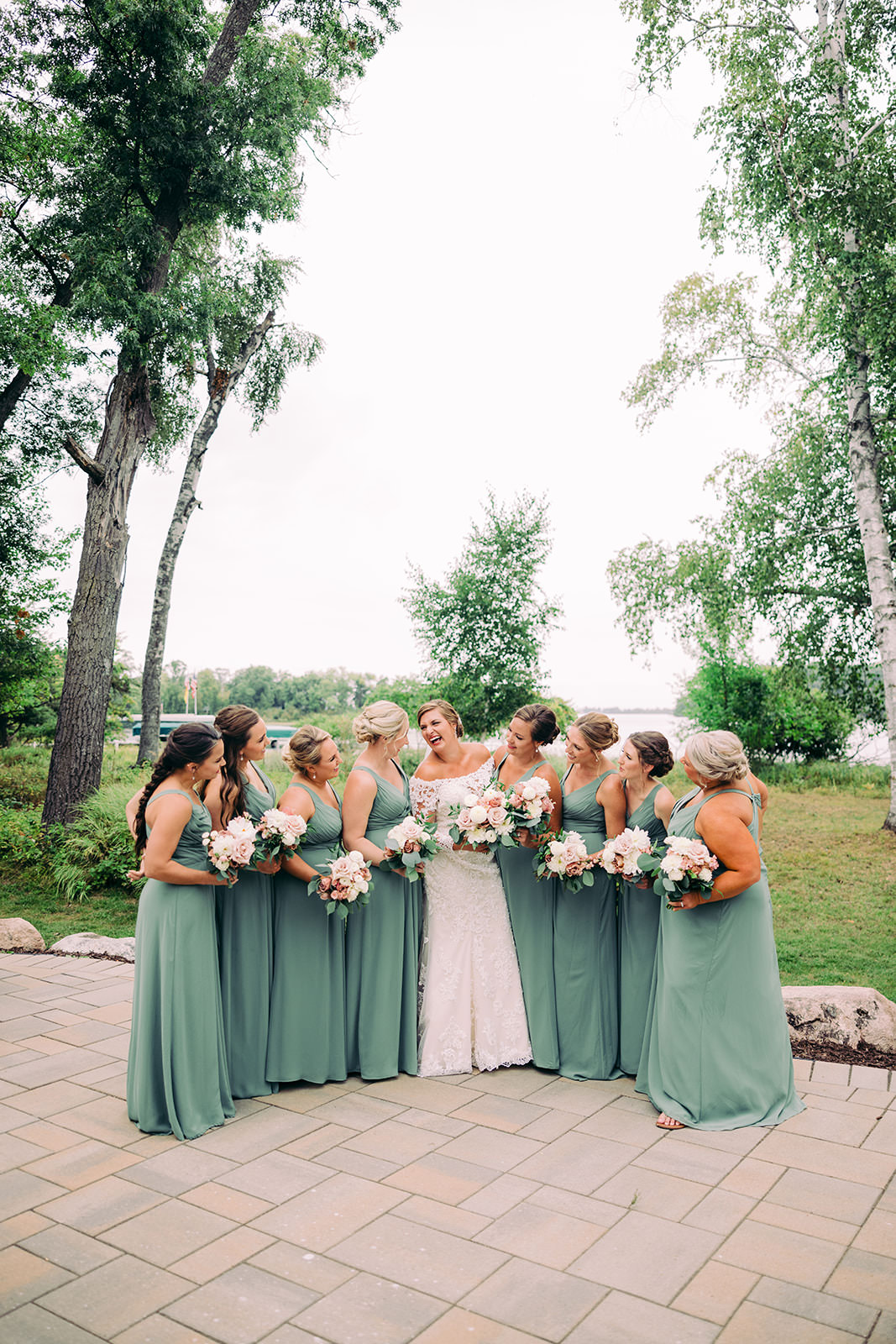 Bridesmaids in sage green dresses with the bride in the center, birch trees and the lake in the background — Tim Larsen Photography, Brainerd Lakes MN