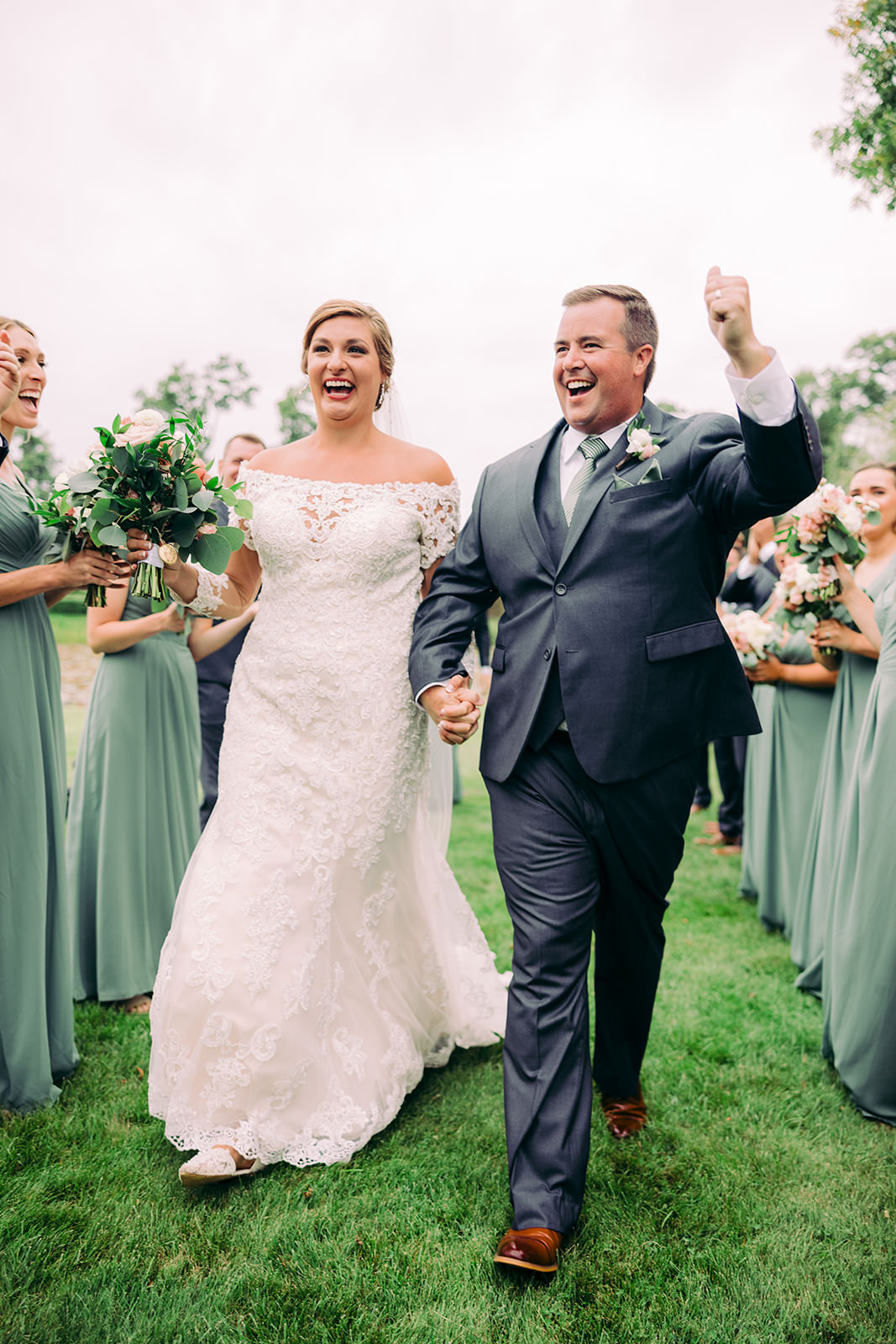 Couple cheered by their bridal party in matching sage green and charcoal — Tim Larsen Photography, Brainerd Lakes MN