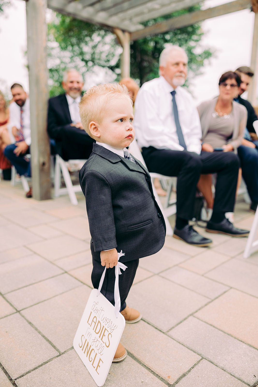Toddler ring bearer in a small suit at the Madden's on Gull Lake ceremony — Tim Larsen Photography, Brainerd Lakes MN