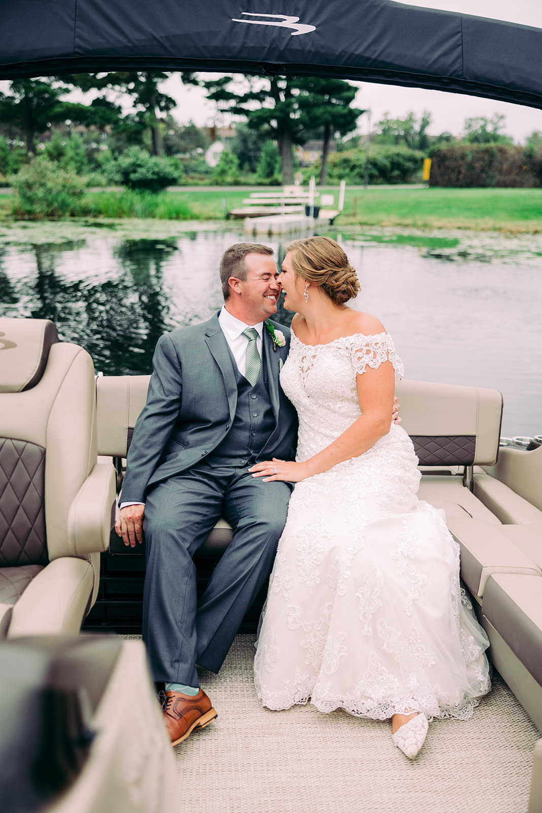 Bride and groom on a pontoon boat on Gull Lake between the ceremony and reception at Madden's — Tim Larsen Photography, Brainerd Lakes MN