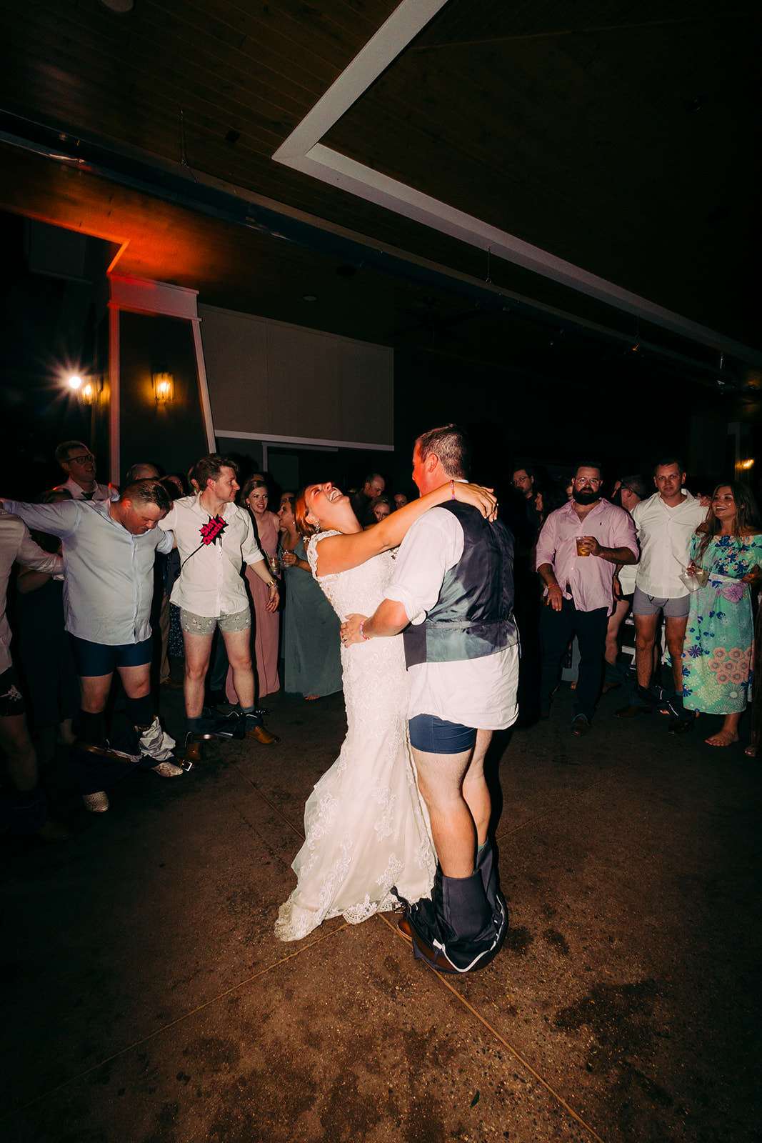 Bride and groom dancing late in the night with guests circled around them — Tim Larsen Photography, Brainerd Lakes MN