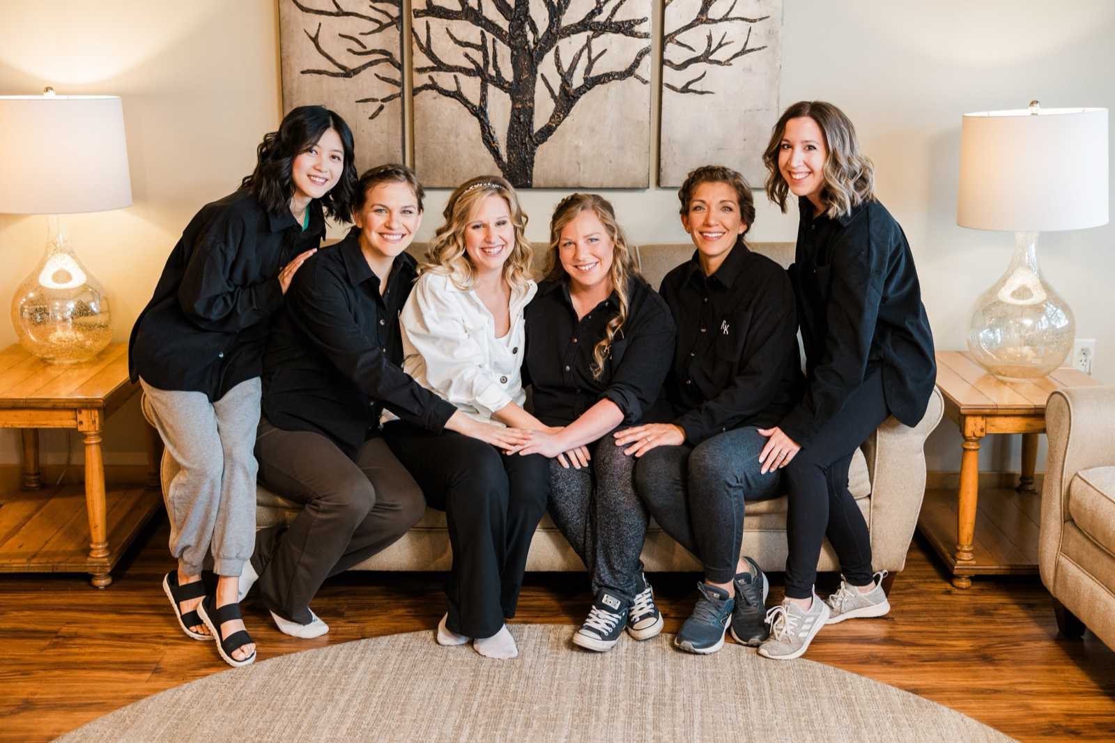 Bride and five bridesmaids in matching black shirts in the getting-ready suite at Madden's on Gull Lake — Tim Larsen Photography, Brainerd Lakes MN