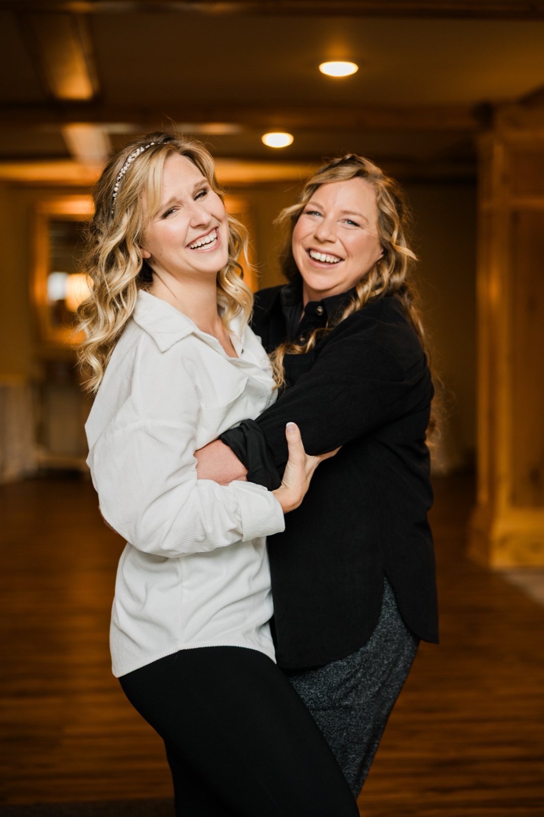 Two friends laughing and embracing inside Madden's on Gull Lake — Tim Larsen Photography, Brainerd Lakes MN