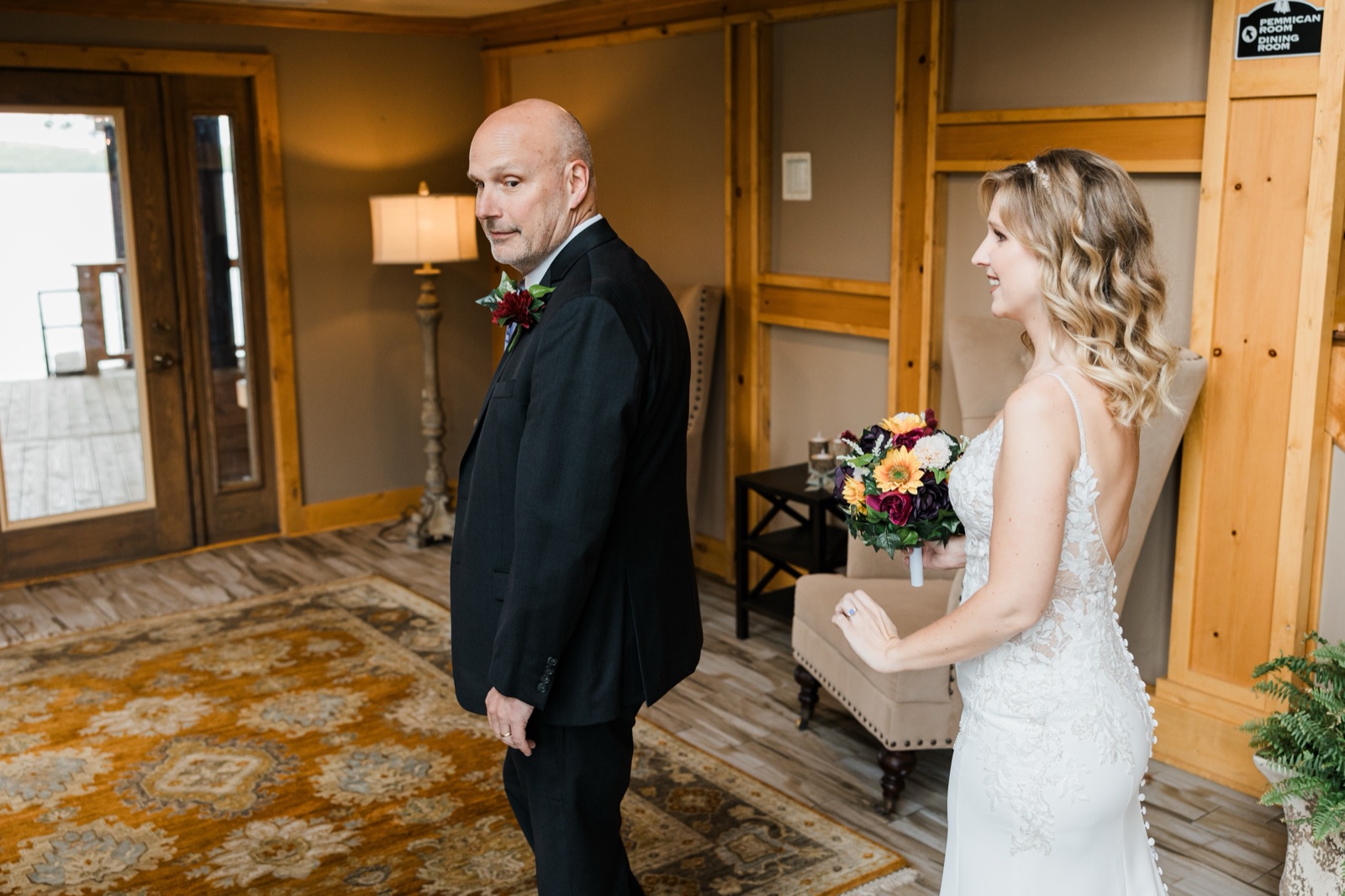 Father turning to see his daughter in her wedding dress for the first time in a Madden's sitting room — Tim Larsen Photography, Brainerd Lakes MN