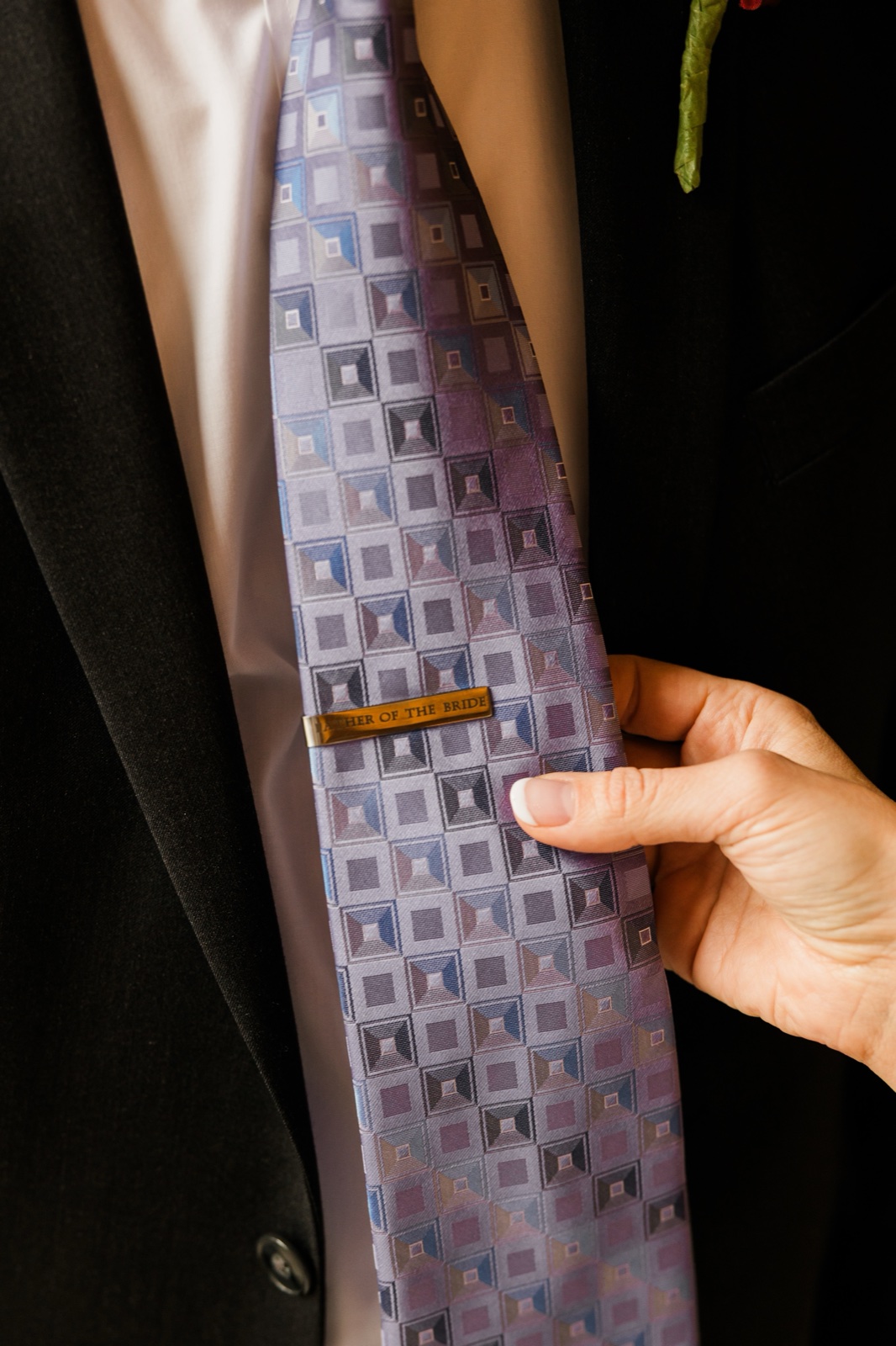 Engraved Father of the Bride tie bar held against a purple paisley tie — Tim Larsen Photography, Brainerd Lakes MN